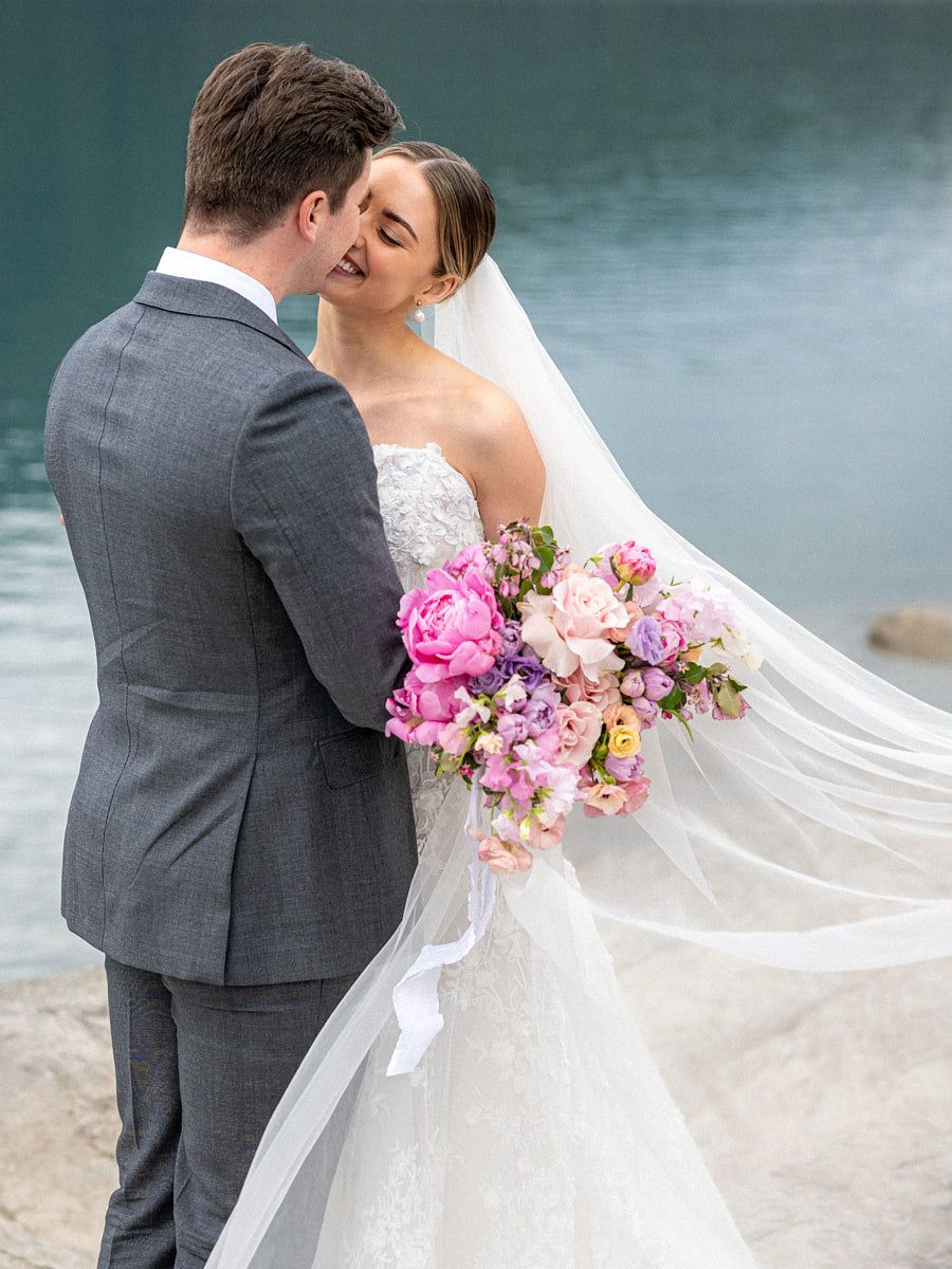 Elegant bride and groom portrait by a scenic European lake, perfect for Riga wedding inspiration
