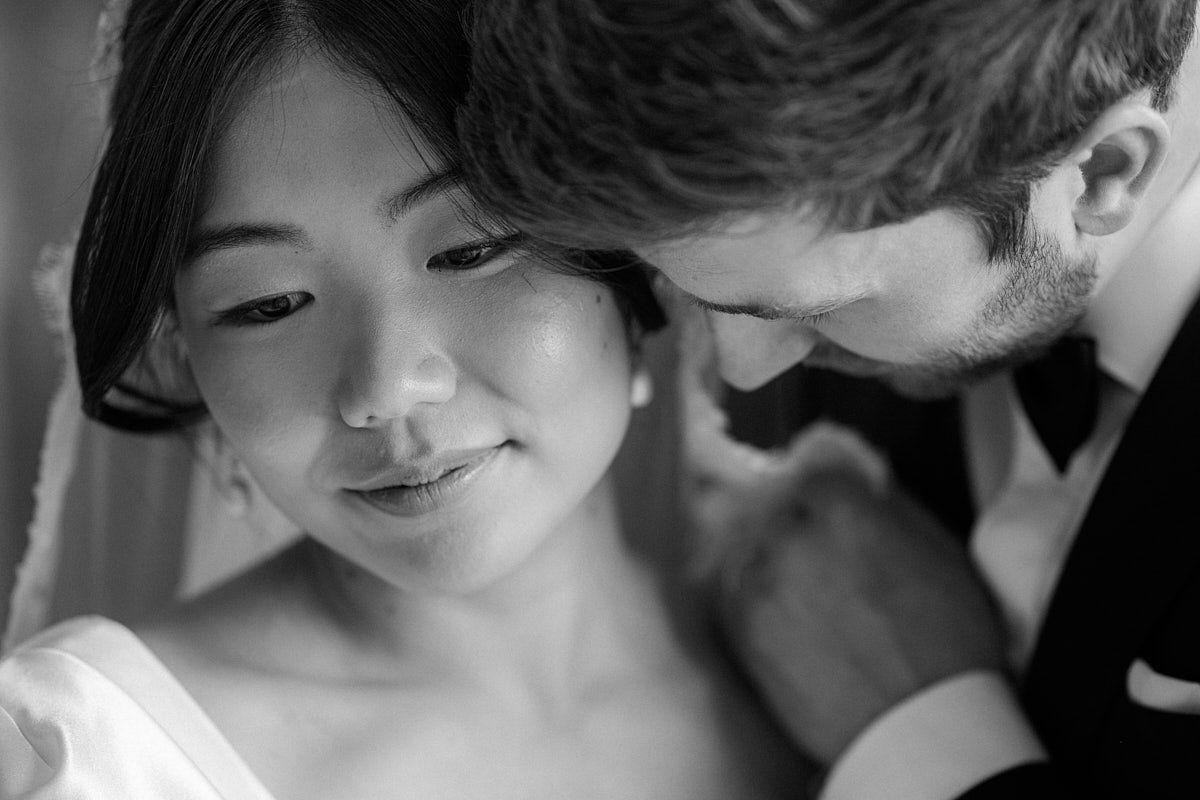 Black and white intimate wedding portrait of bride and groom, capturing timeless Riga wedding emotions