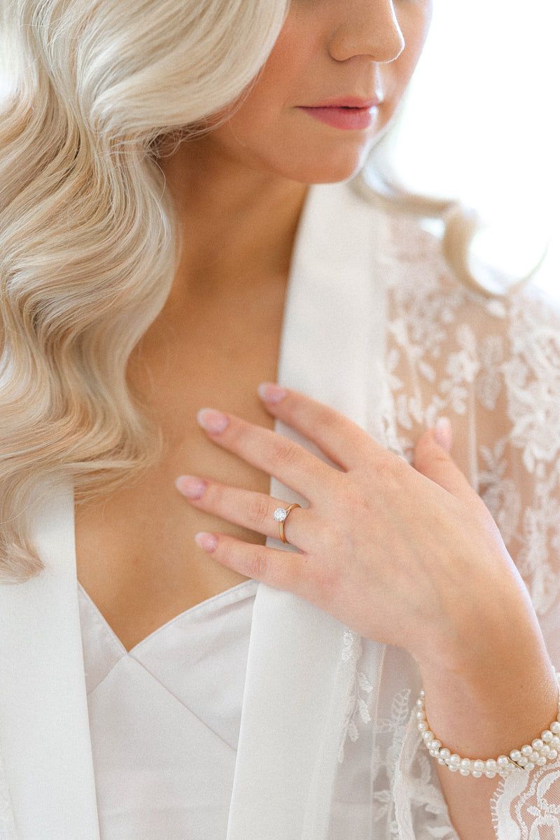 Bride preparing for wedding while showcasing her ring, capturing elegant Riga wedding details