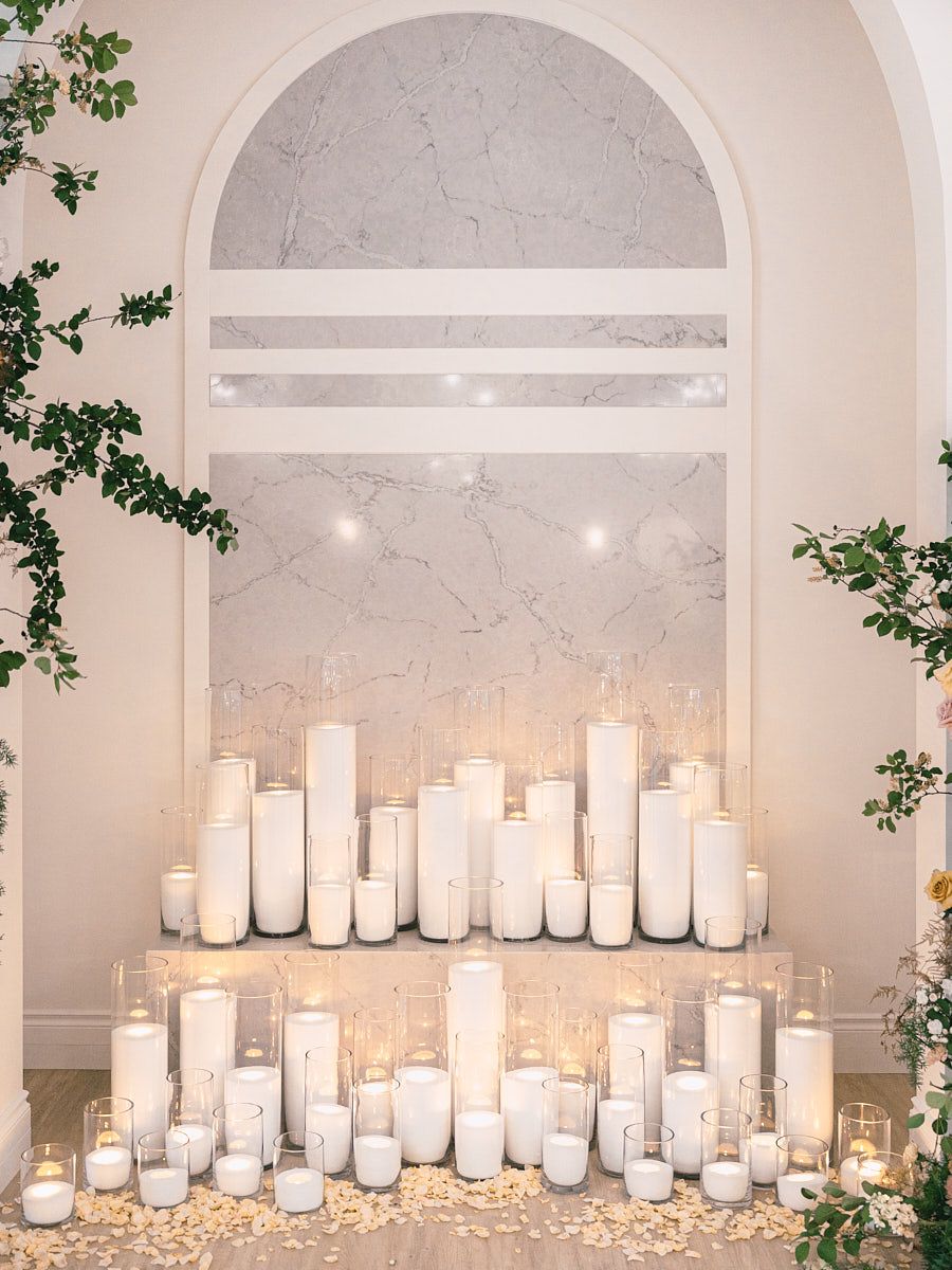 Elegant wedding arch with candles, cozy and warm ceremony setting in Riga venue