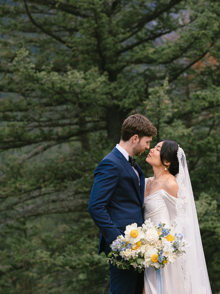 Bride and groom enjoying intimate moments in front of a European forest castle