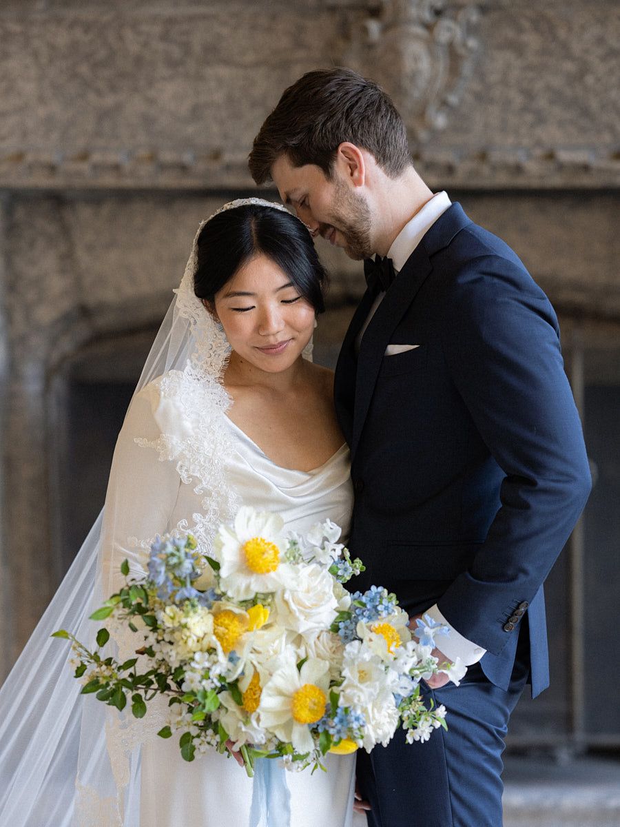 Bride and groom captured in timeless castle architecture for Riga wedding photography