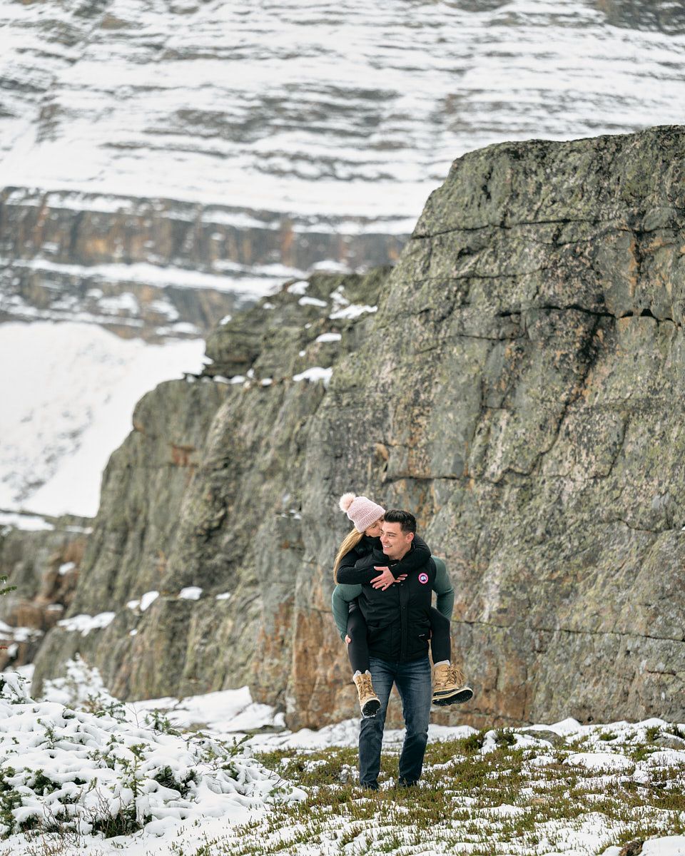 Engaged couple walking through snowy landscape, winter engagement session in Europe
