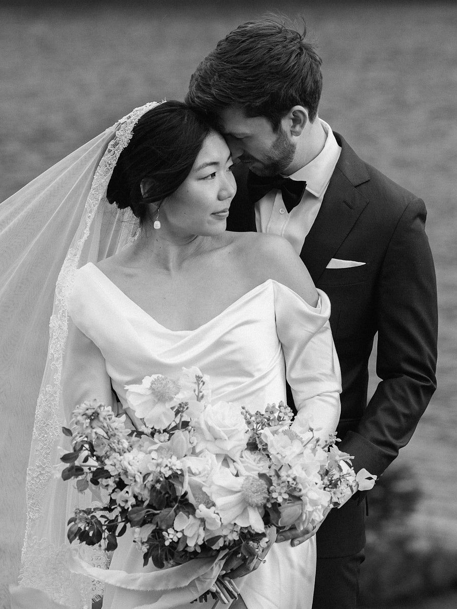 Intimate bride and groom moment by a calm forest lake, captured for Riga weddings