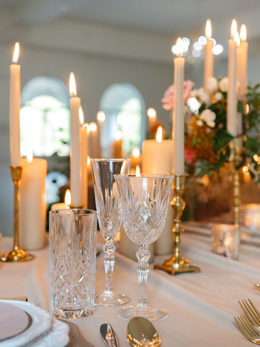 Elegant glassware and candles on Riga wedding reception table, styled for a romantic evening ambiance