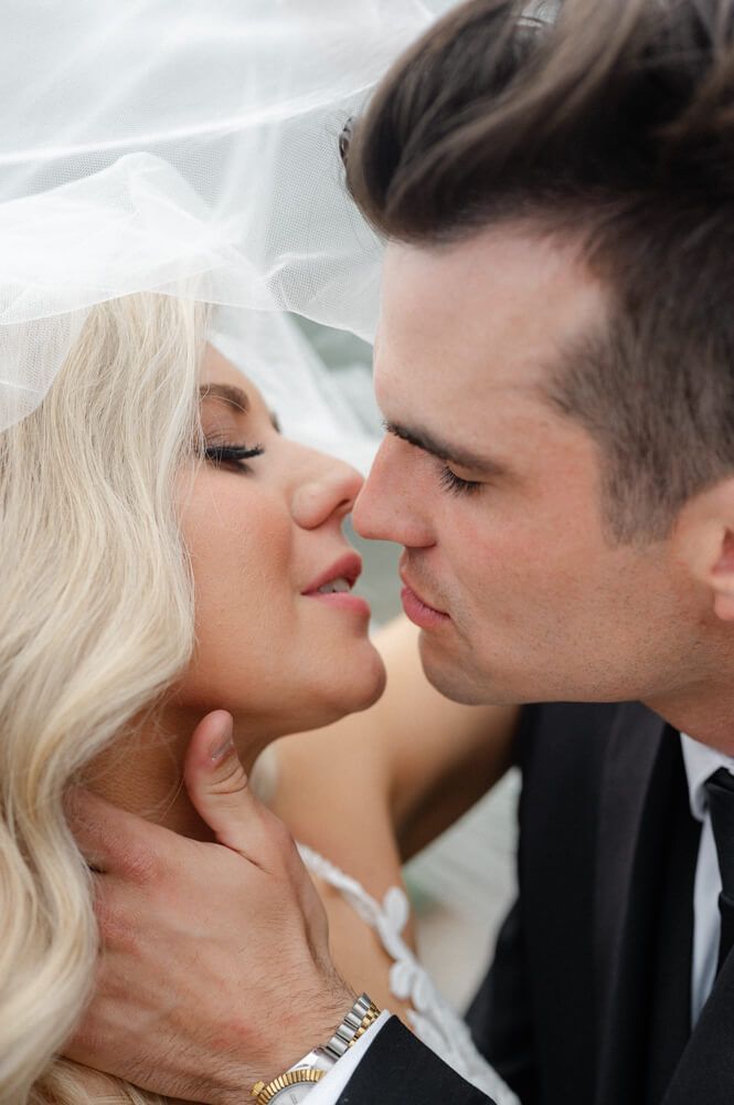 Close-up of bride and groom sharing a kiss, capturing a tender Riga wedding moment