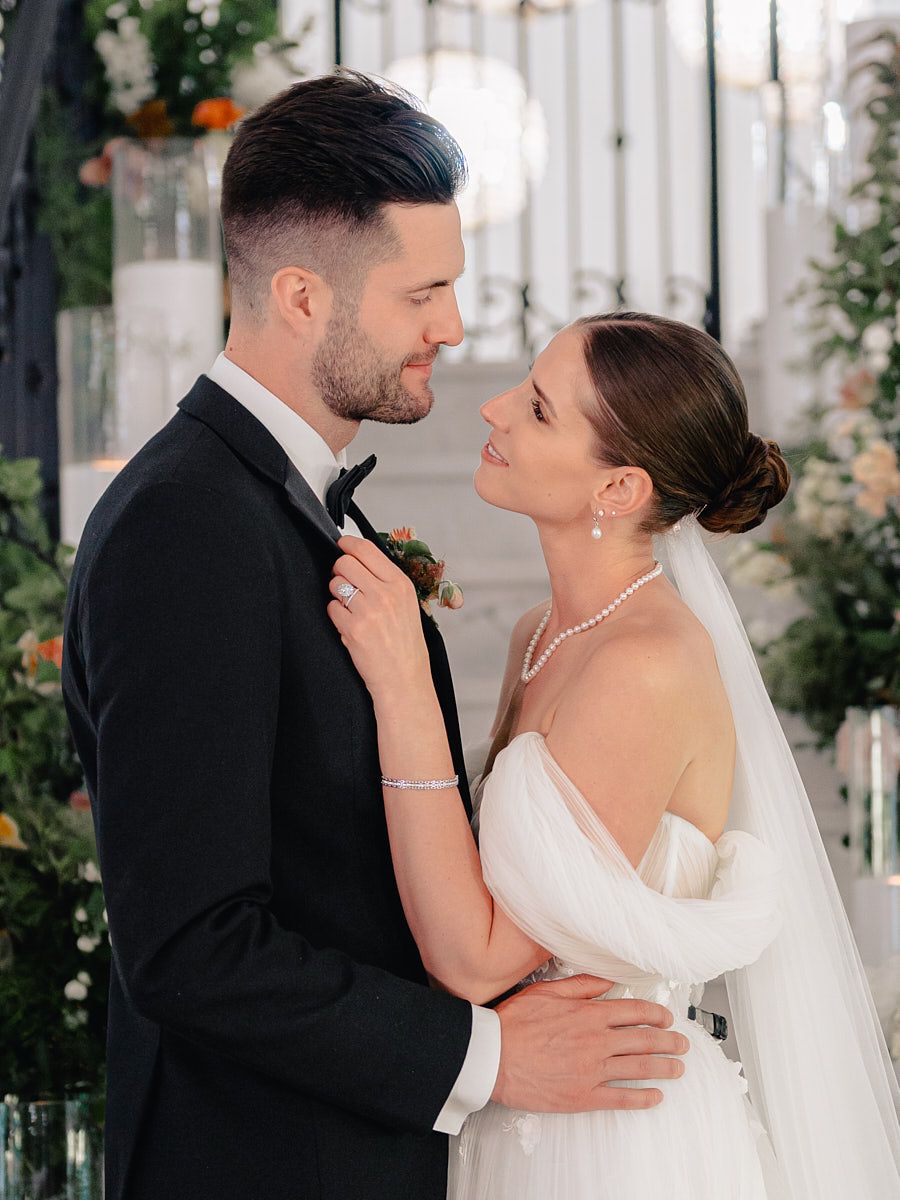 Romantic Riga wedding portrait of bride and groom on staircase with floral accents