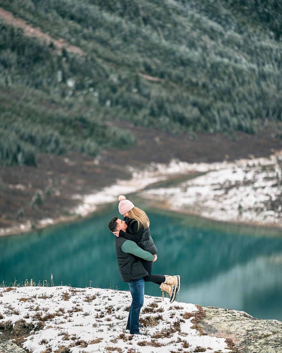 Man proposing to fiancée atop scenic Canadian mountains