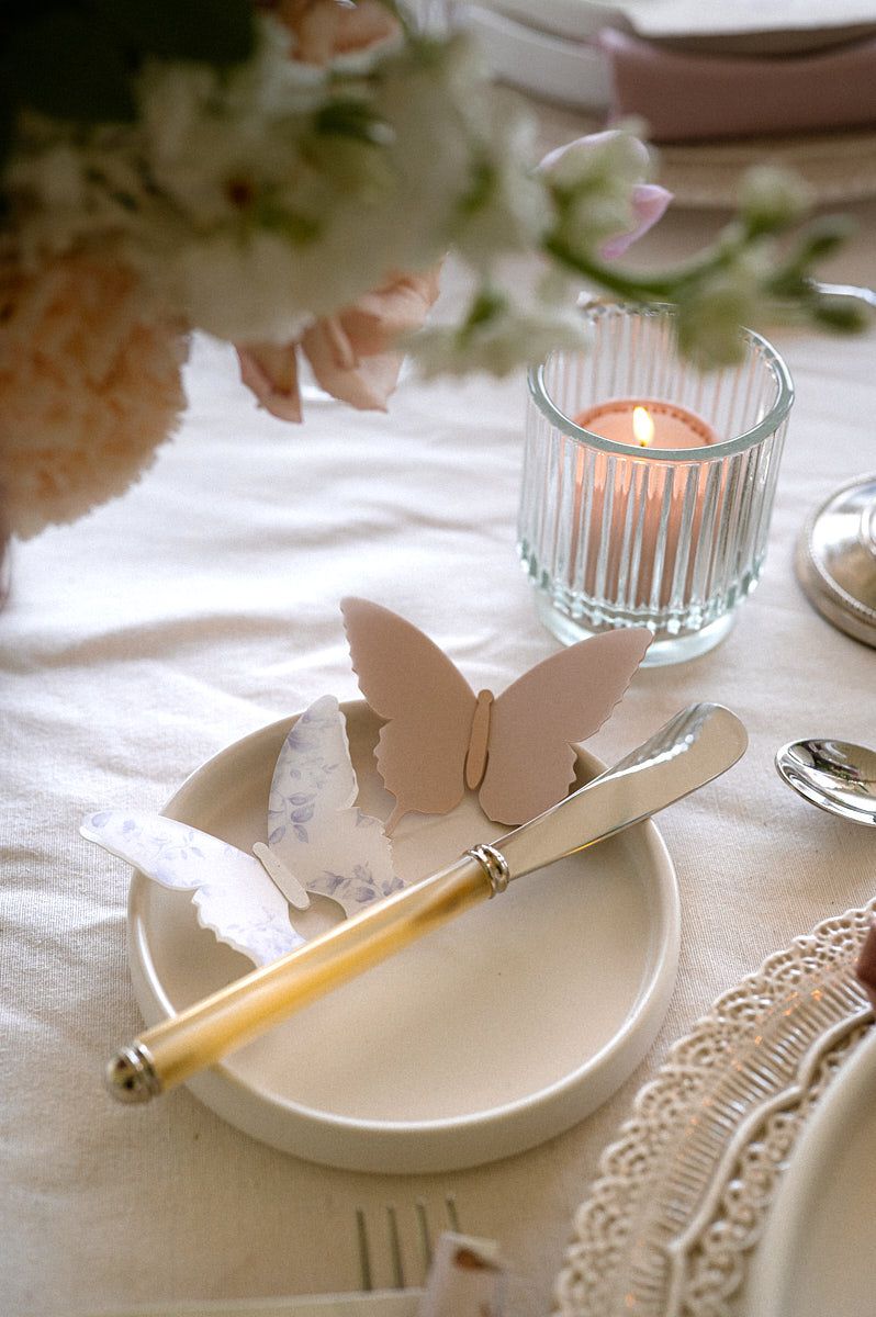 Stylish pastel table decor with coordinated plates, glasses, and floral accents