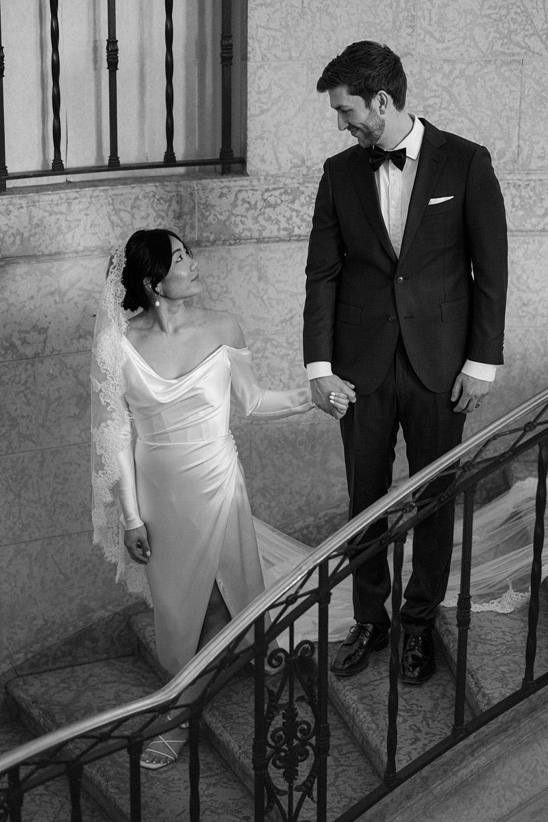 Romantic bride and groom enjoying private moment on castle stairs, ideal for Riga wedding photography