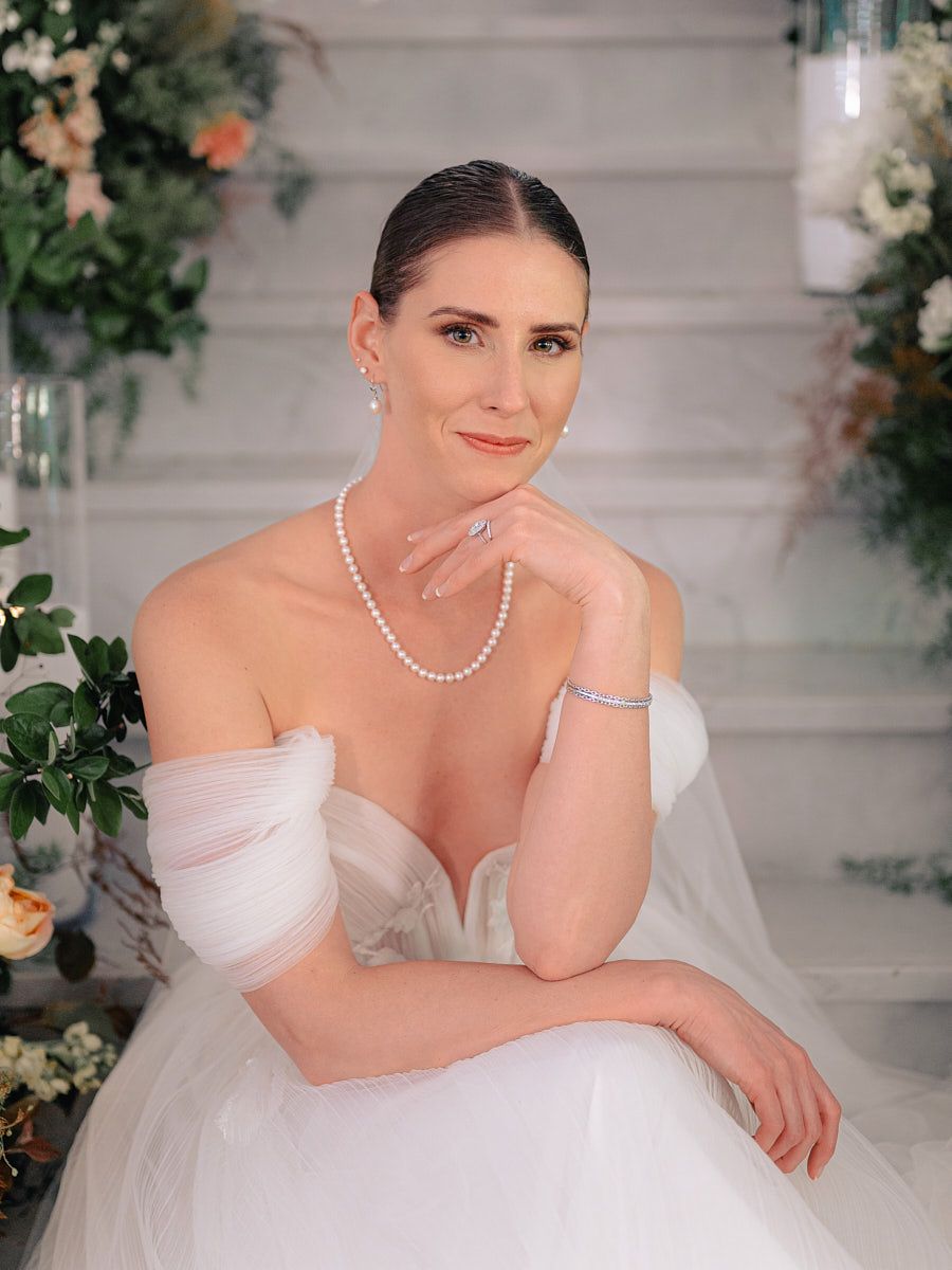 Stunning bride at Riga grand stairs, sophisticated wedding portrait with flowing gown
