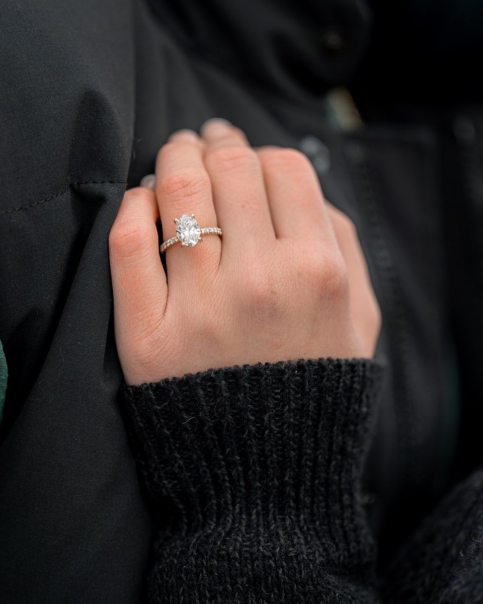 Diamond engagement ring on fiancée’s hand, close-up engagement detail