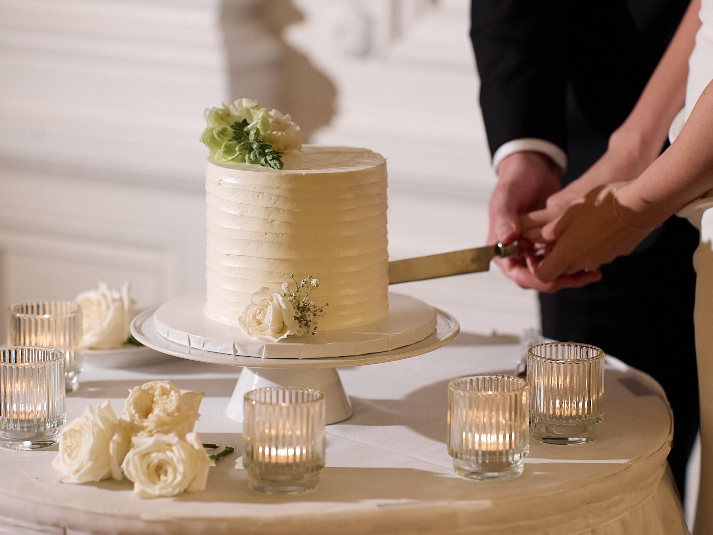 Bride and groom cutting their wedding cake in Riga