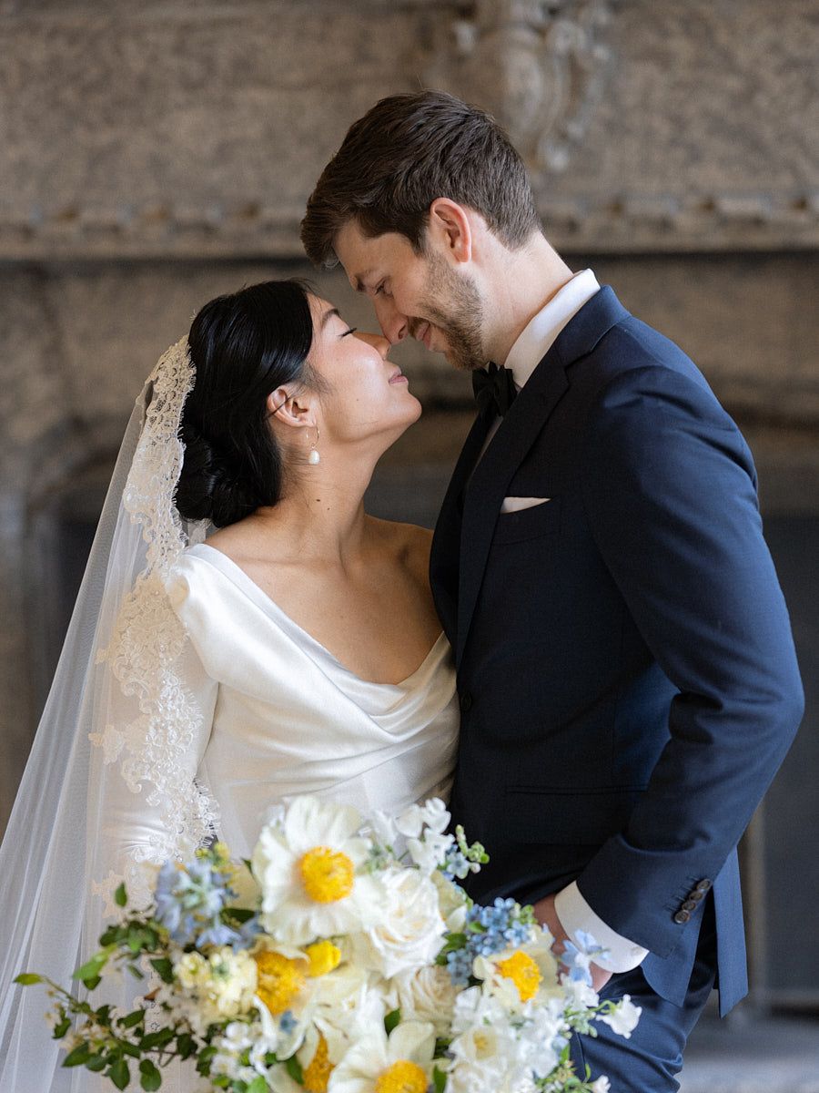 Intimate castle portrait of bride and groom in European wedding attire