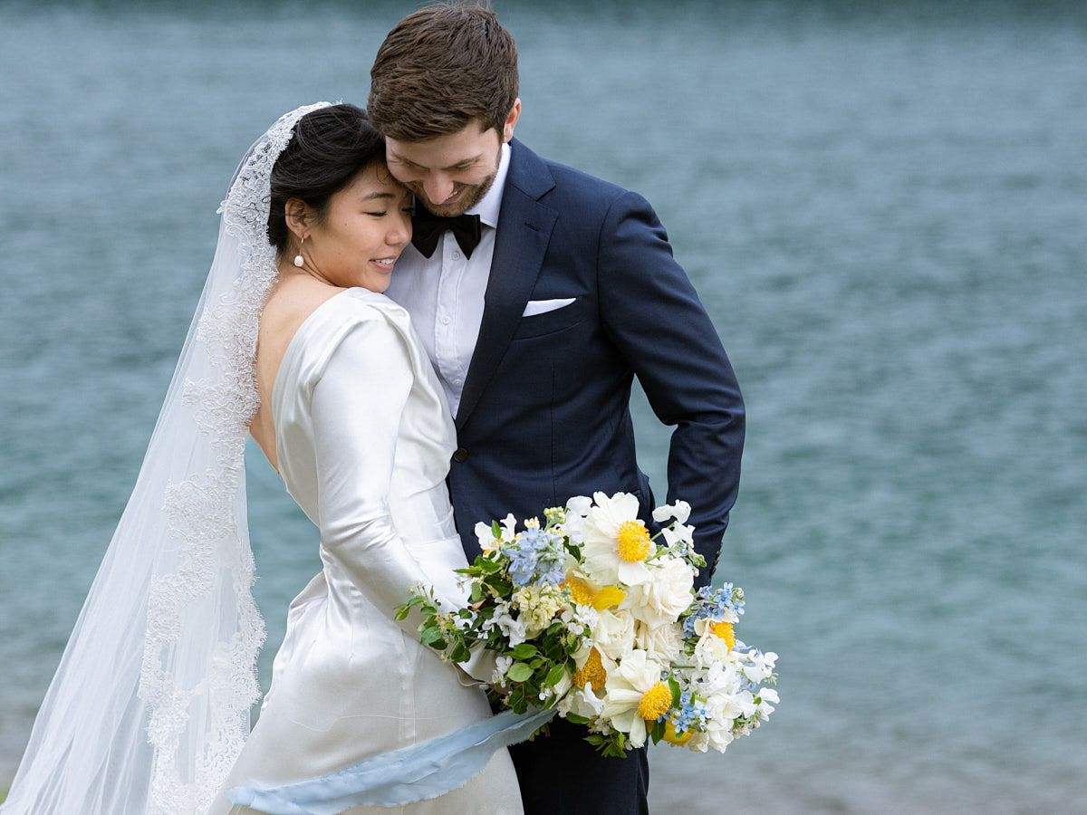 Baltic-inspired wedding portrait of couple near a picturesque forested lake