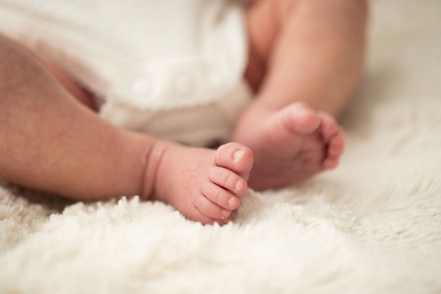 Close-up detail shots of tiny newborn feet and toes.