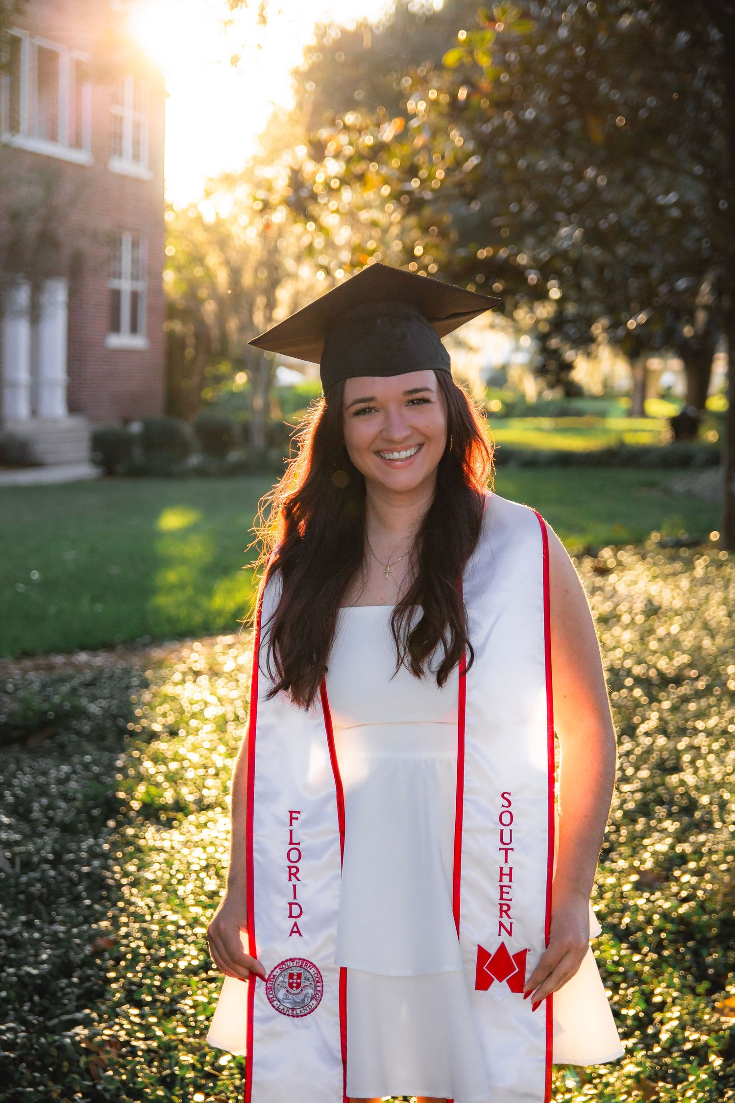 Graduation photos at sunset show a graduate in cap and gown with red honor cords against golden sunlit foliage.