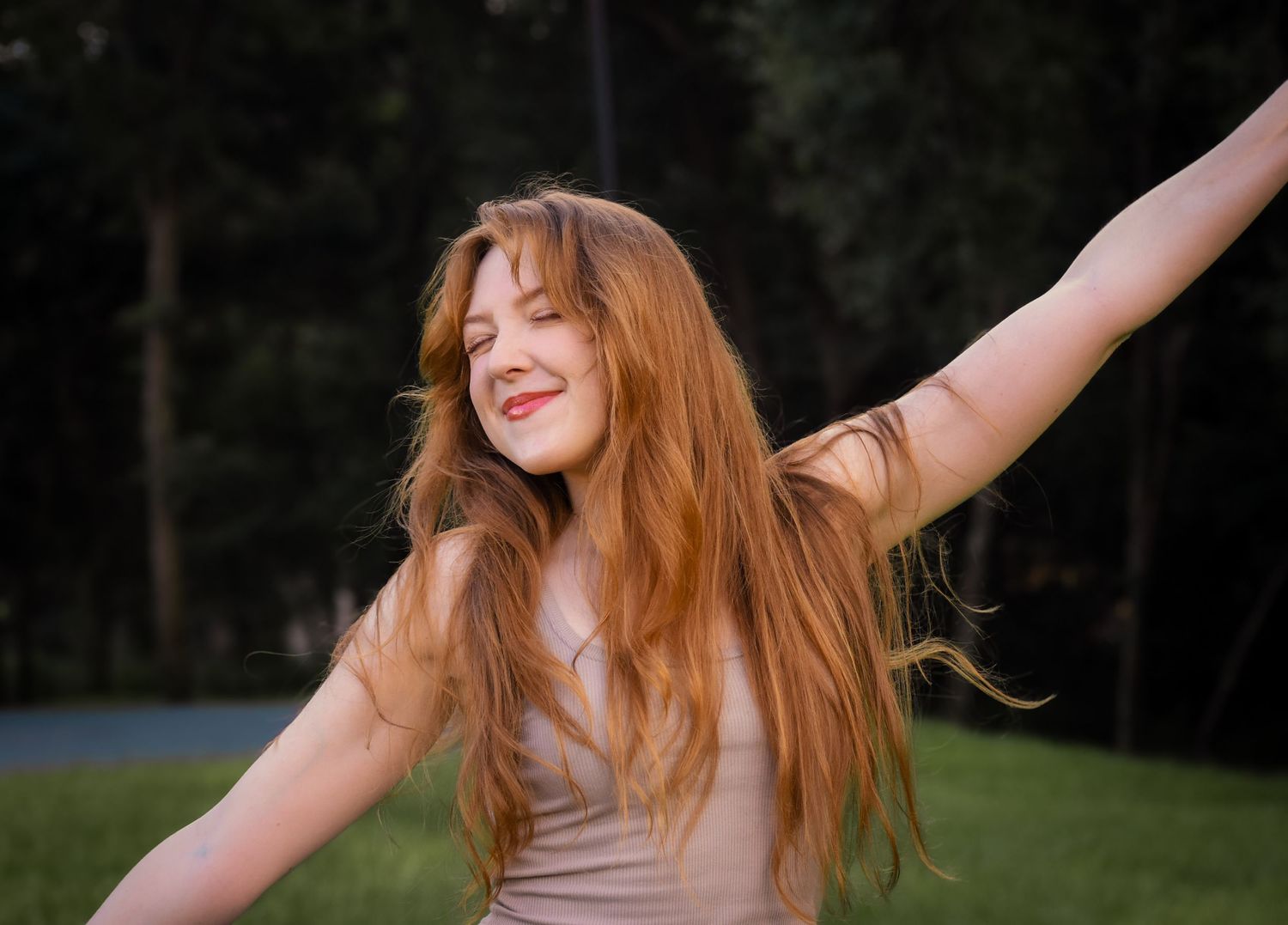 Outdoor portrait session in a grassy field during golden hour.