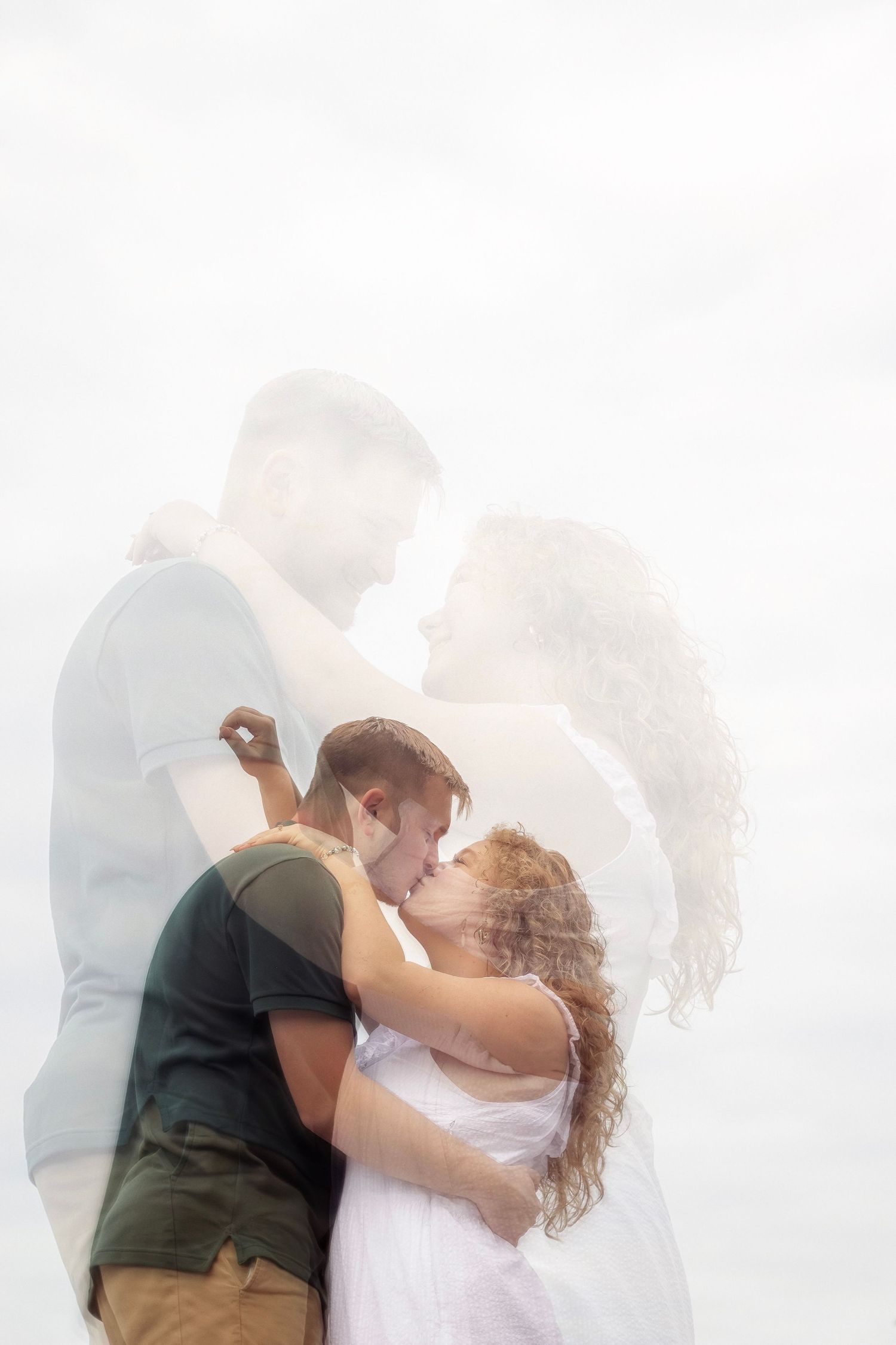 Ethereal couple portrait with soft white backlight creating dreamy atmosphere.
