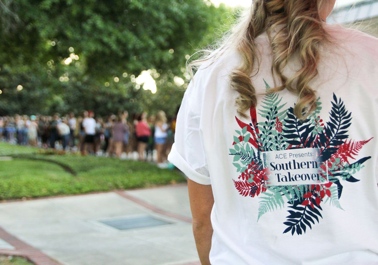 White t-shirt with tropical floral design and text displayed in multiple product angles.