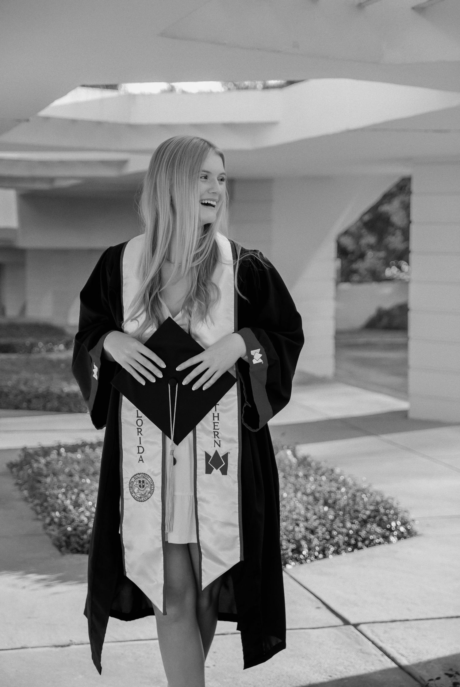 A series of graduation photos showing a graduate in black cap and gown with white stole posing outdoors on campus.