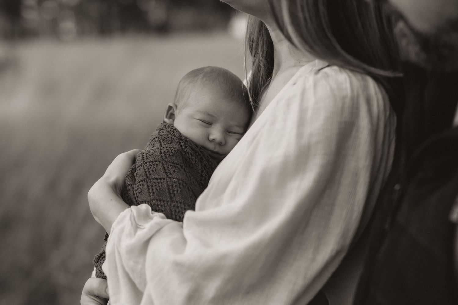 Tender black and white portrait of an intimate newborn moment.