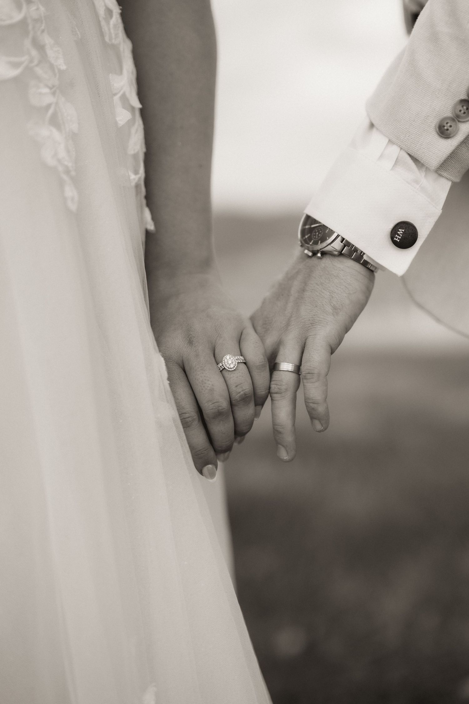 Close-up black and white detail shots of wedding rings and hands showing intricate jewelry details.