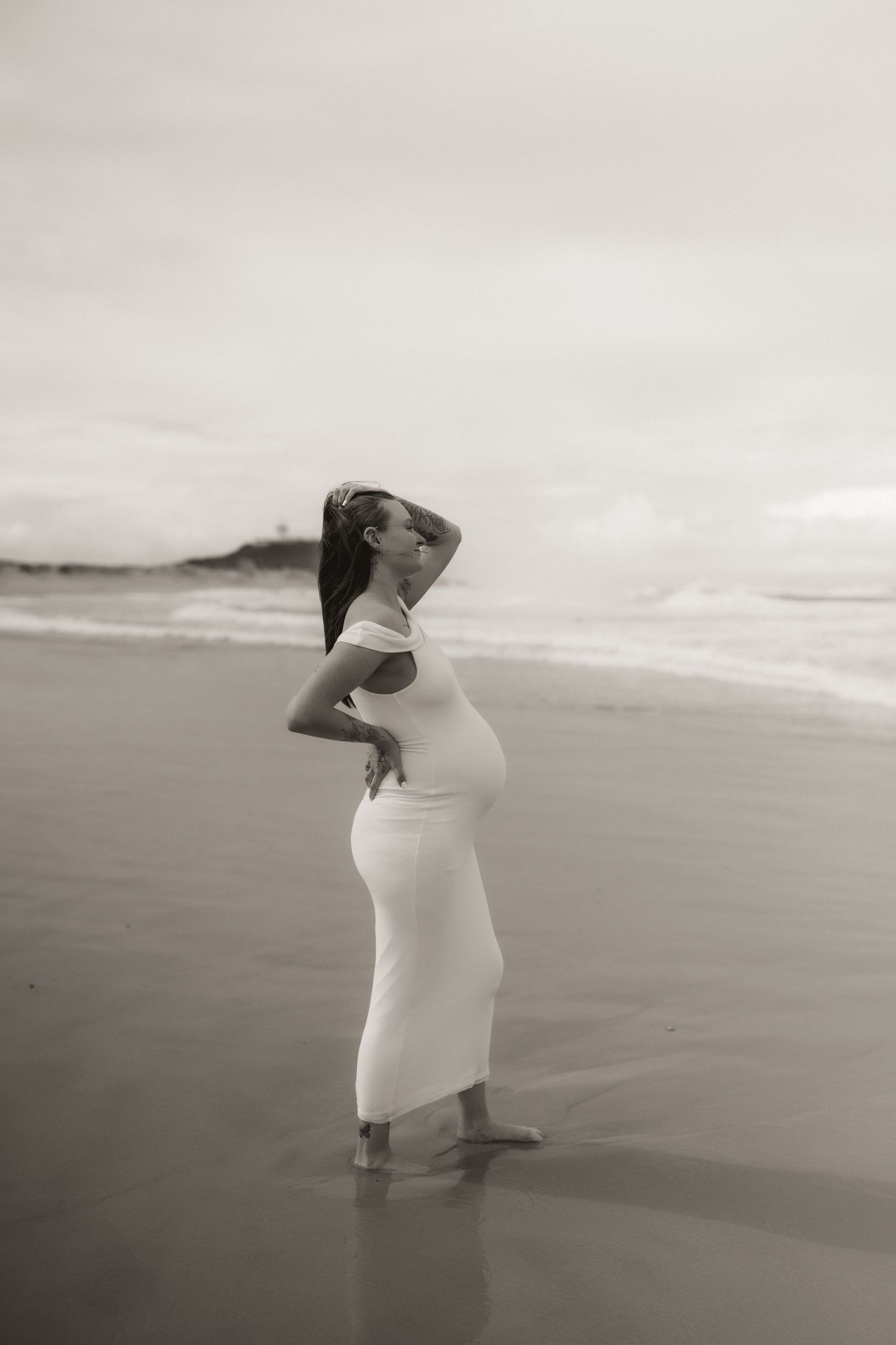 A series of artistic maternity photos on a beach in black and white.