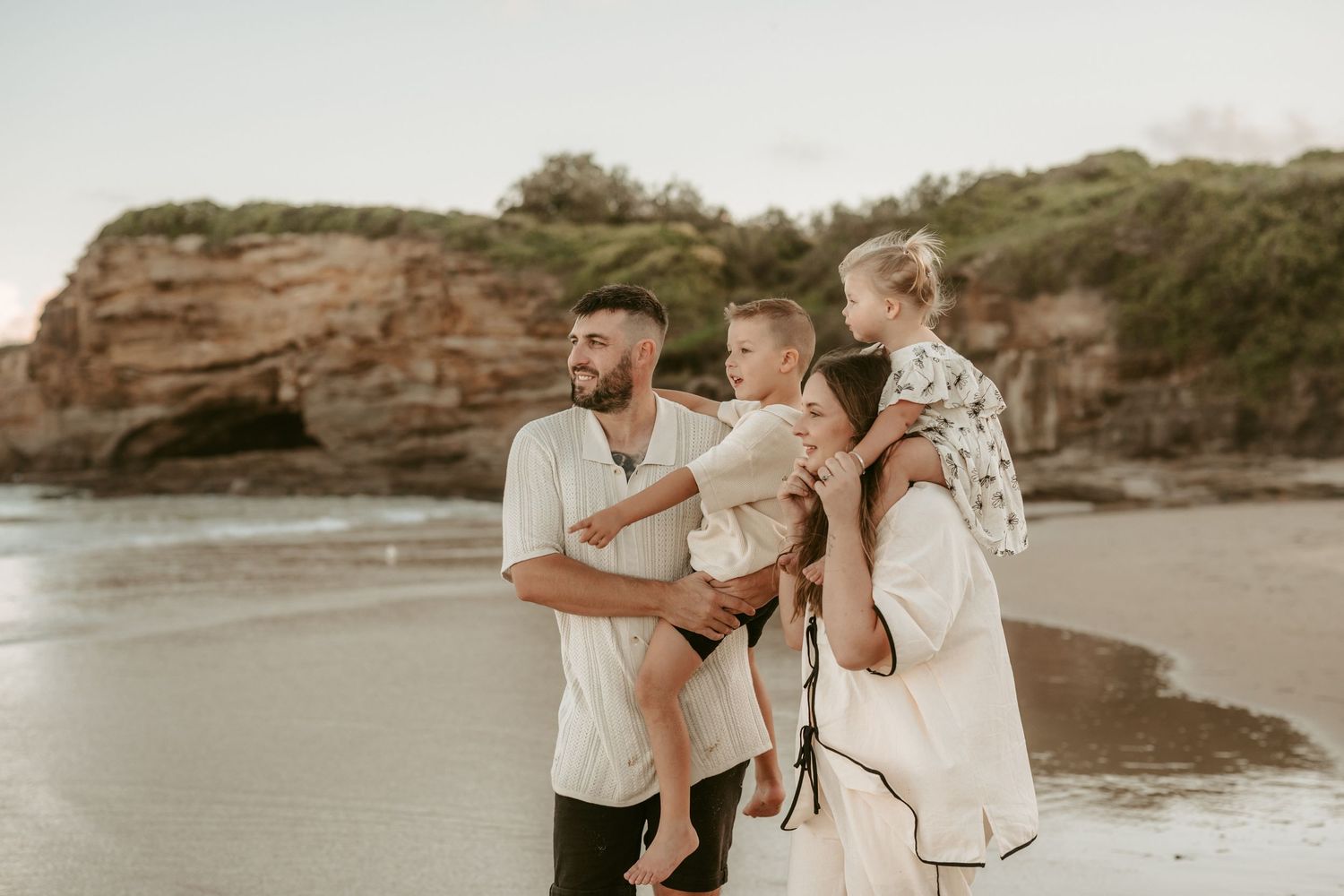 Couple shares intimate moments at sunset on a rocky beach in a series of romantic photos.
