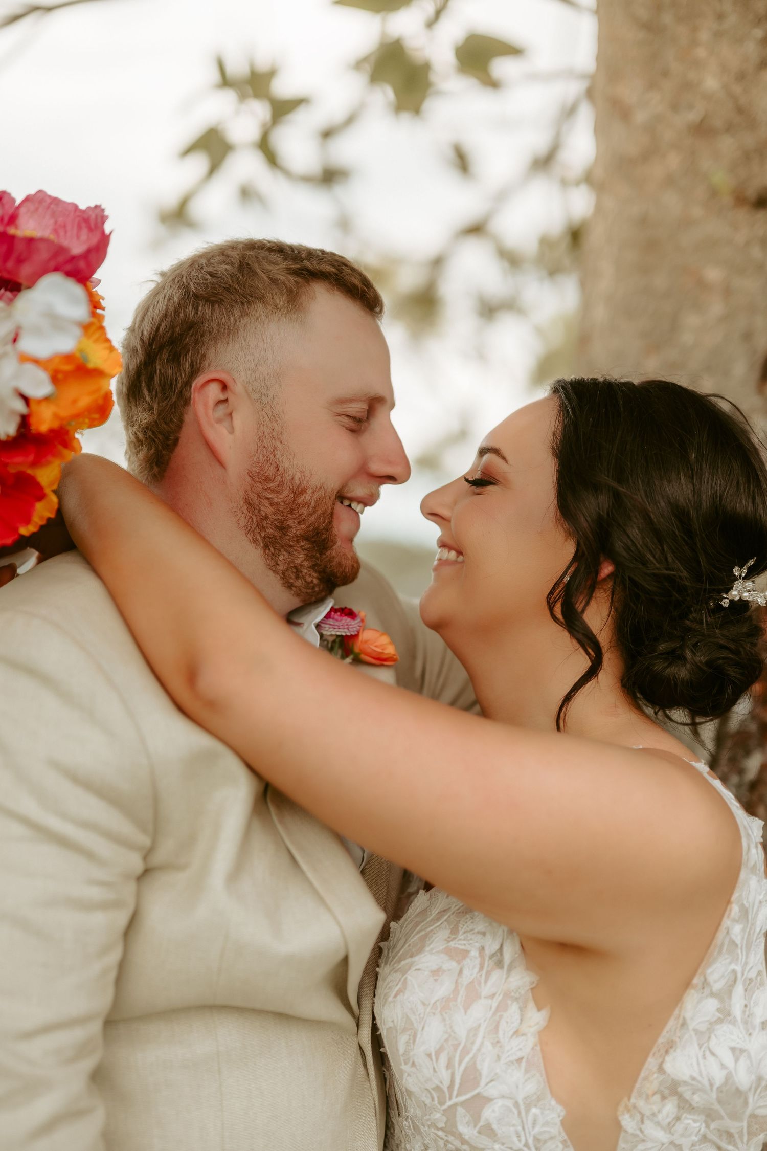 Intimate wedding couple portraits showing tender moments against natural backdrop.