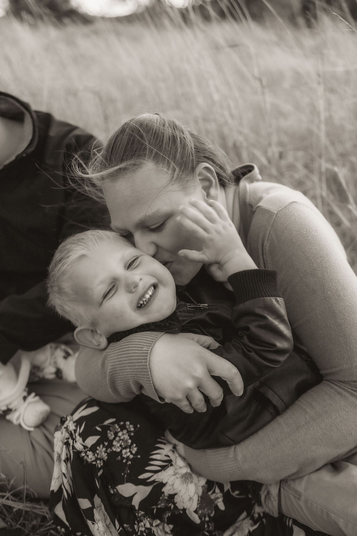 Intimate black and white family portrait showing affectionate moments.