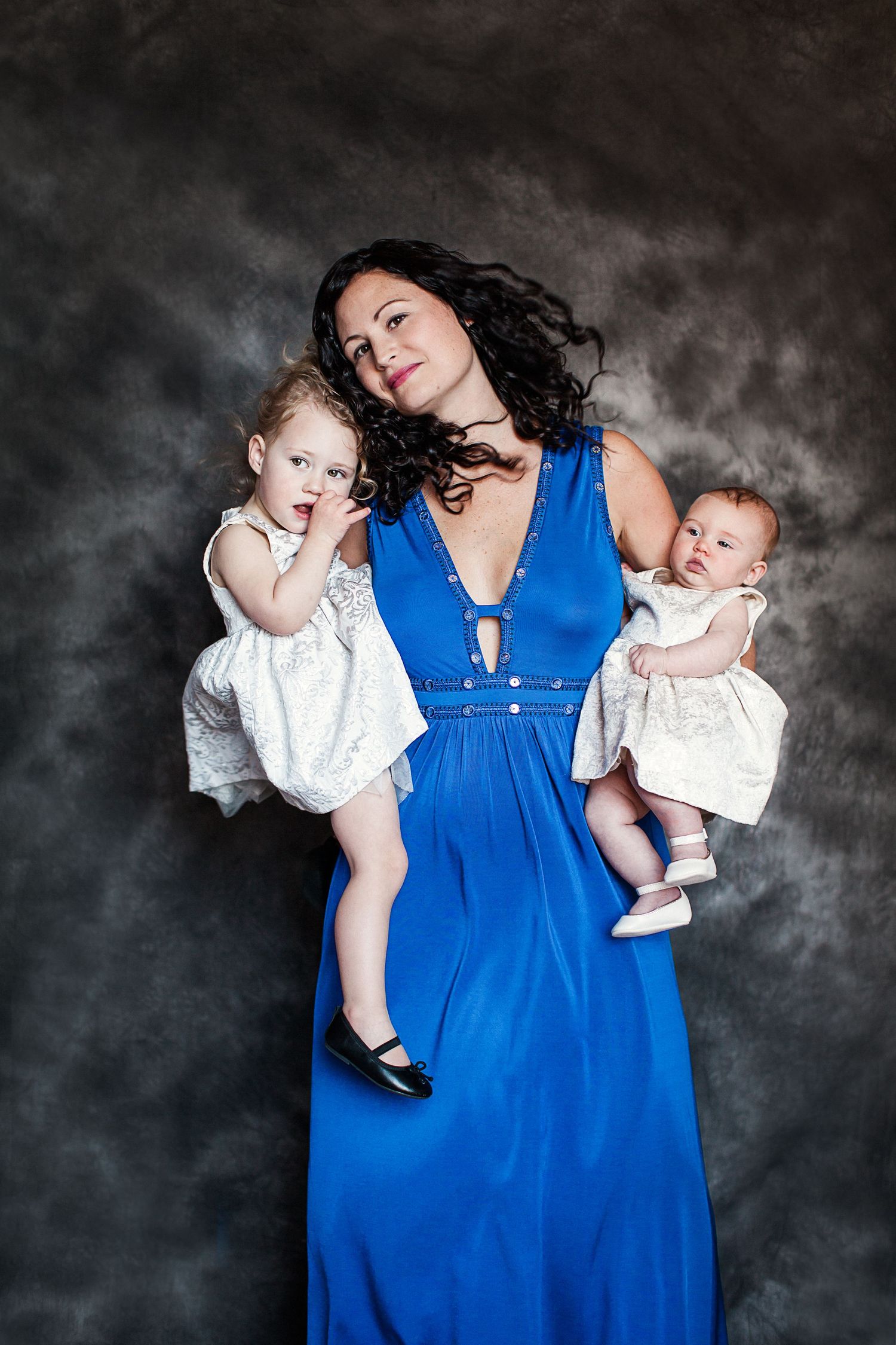 Studio photo of mother and daughters.