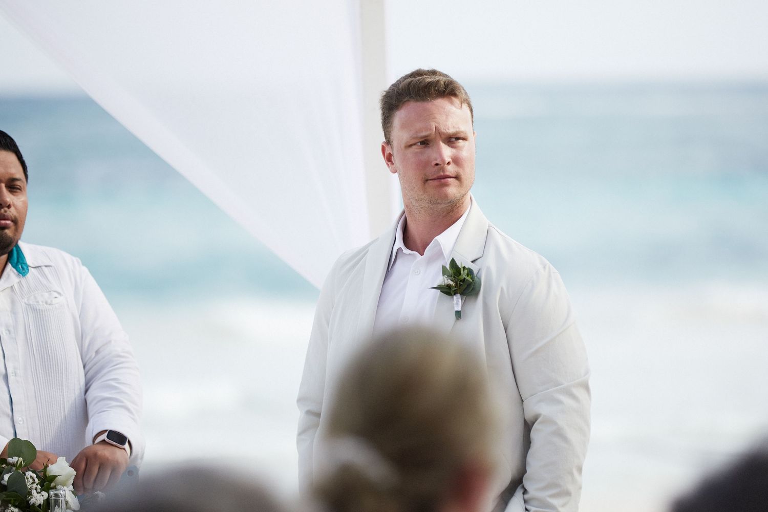 Groom looking emotionally at bride walking down the aisle.