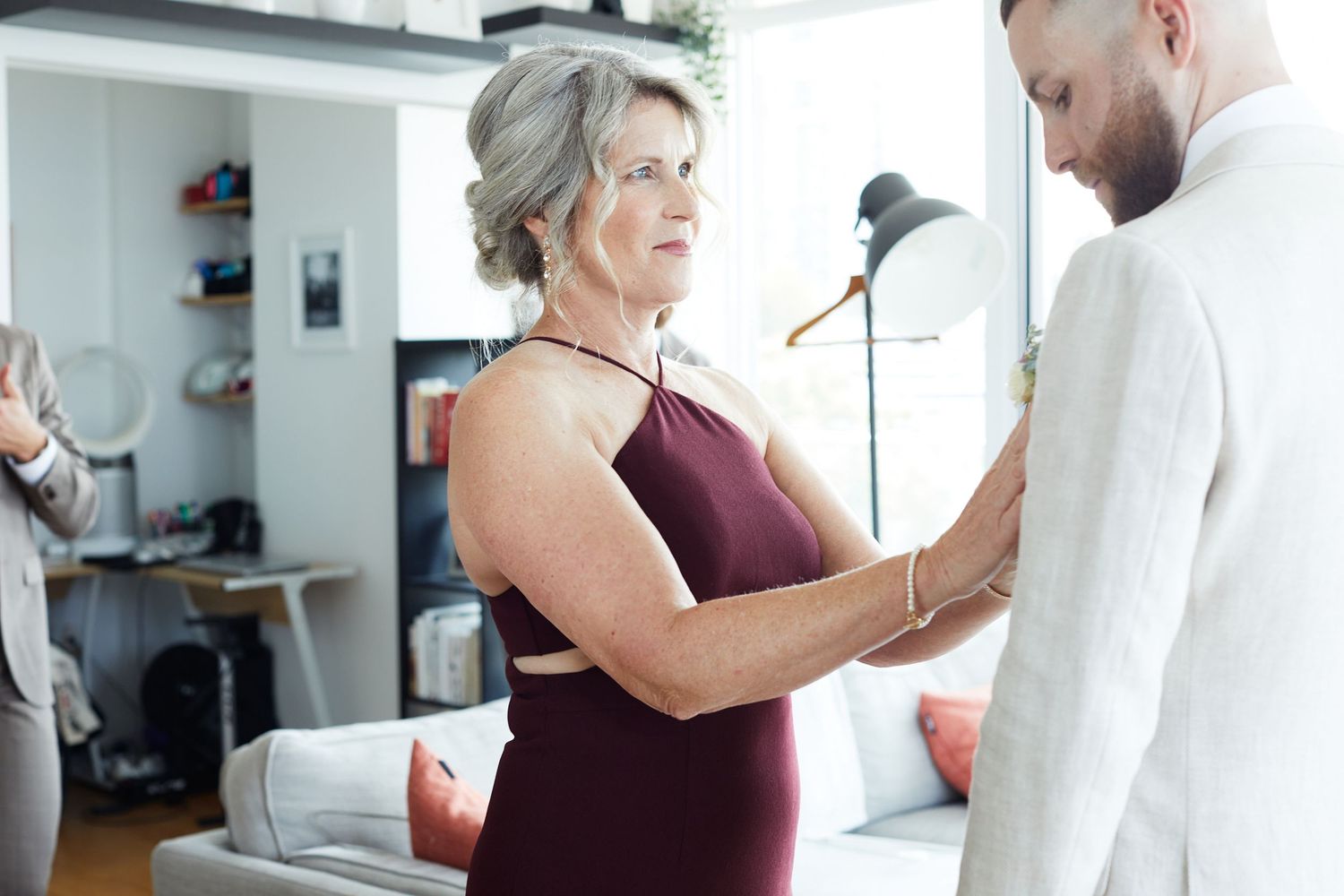 Portrait of groom and grooms mother getting ready.