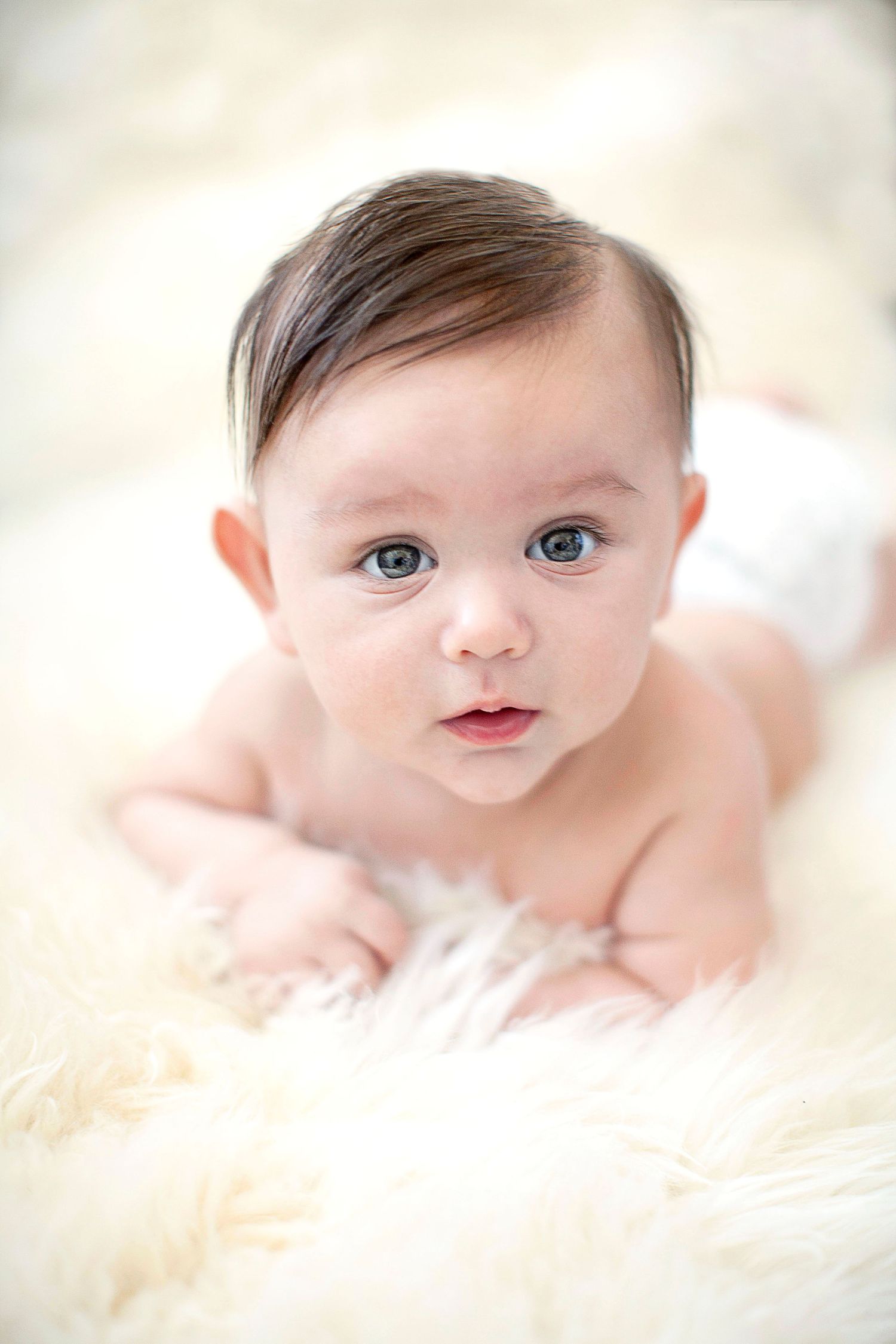 Closeup of baby on a sheepskin rug.