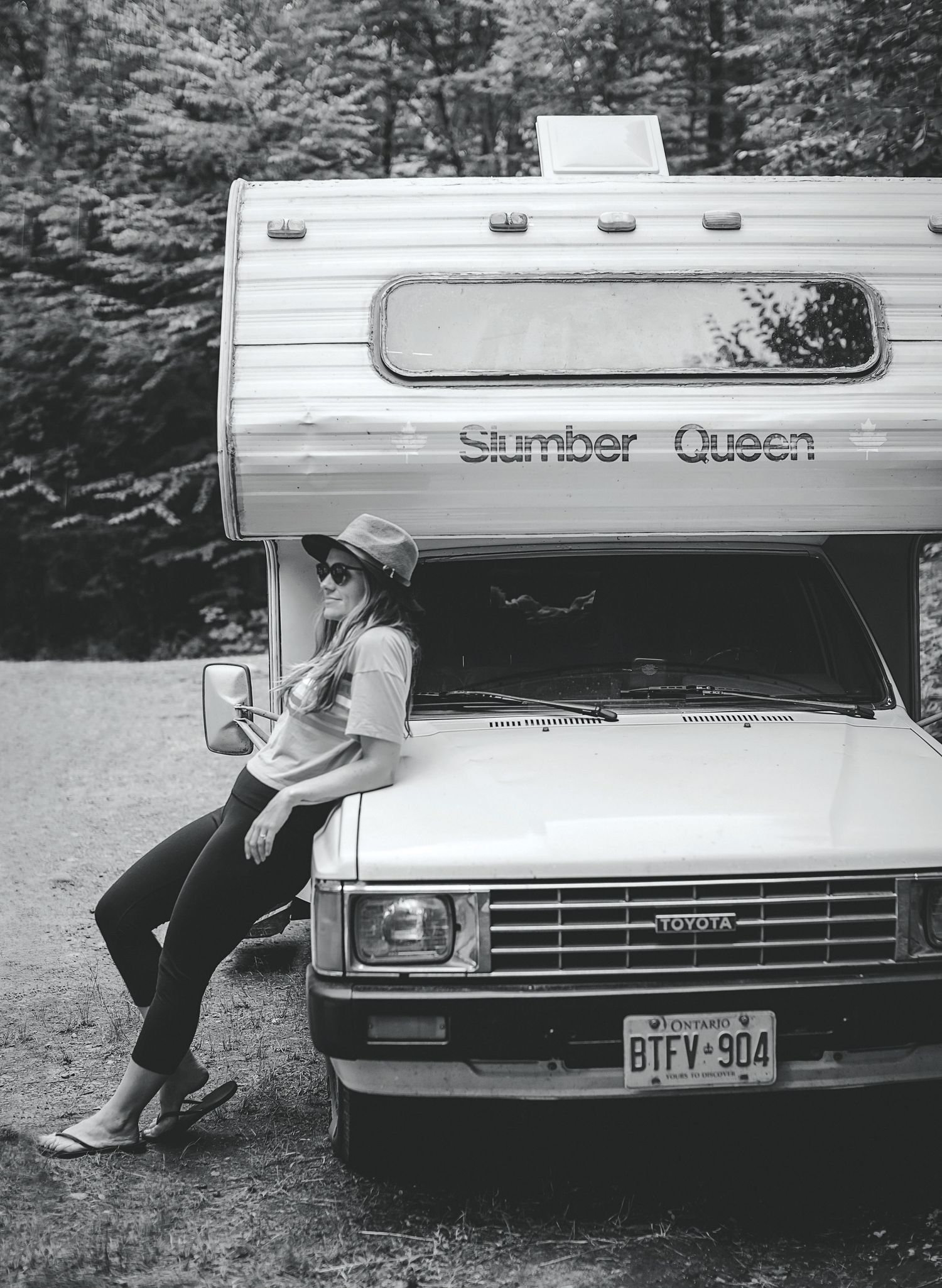 Photo of camper leaning on a vintage RV.