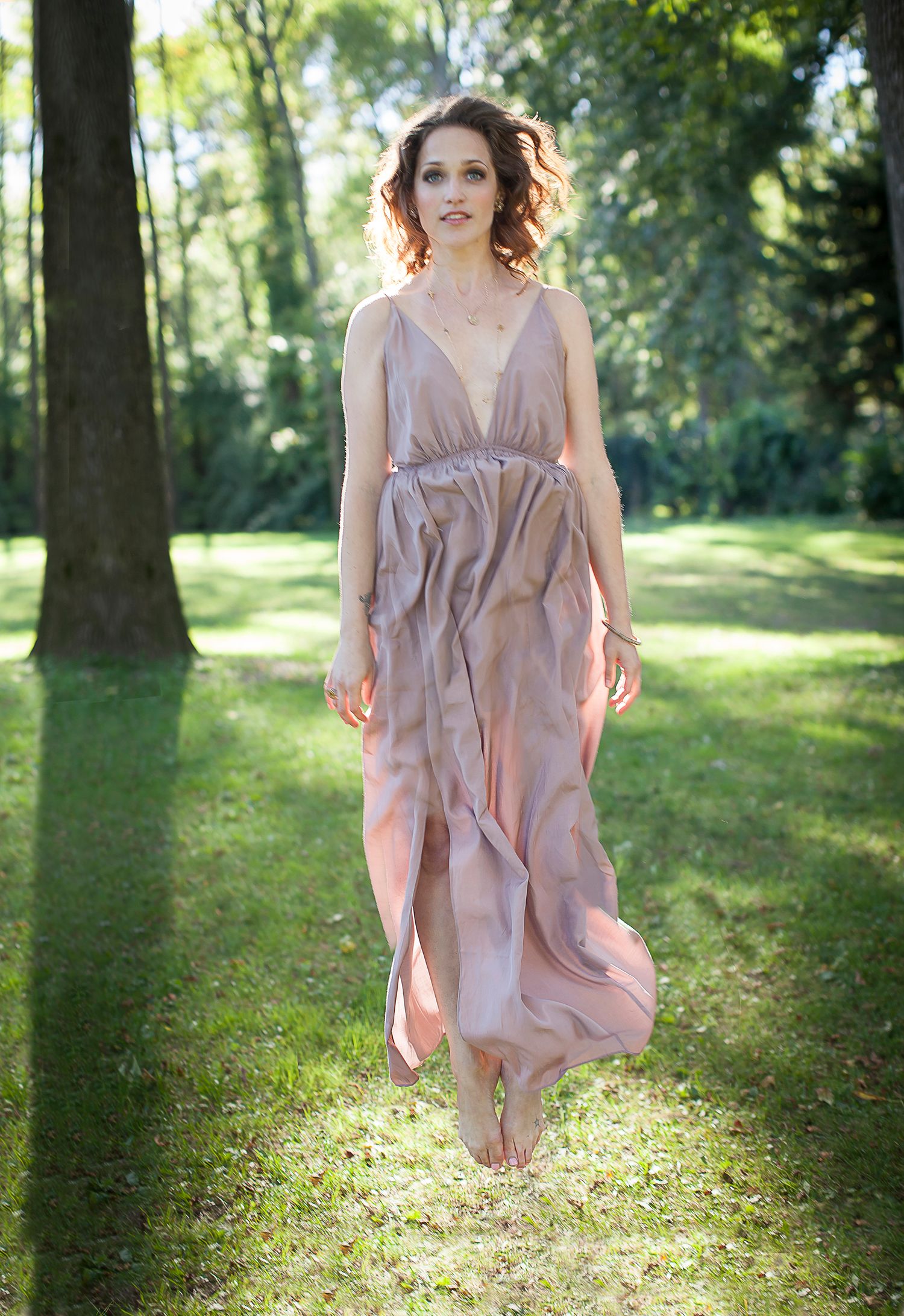 Model jumping in pink dress at Guildwood Park, Toronto.