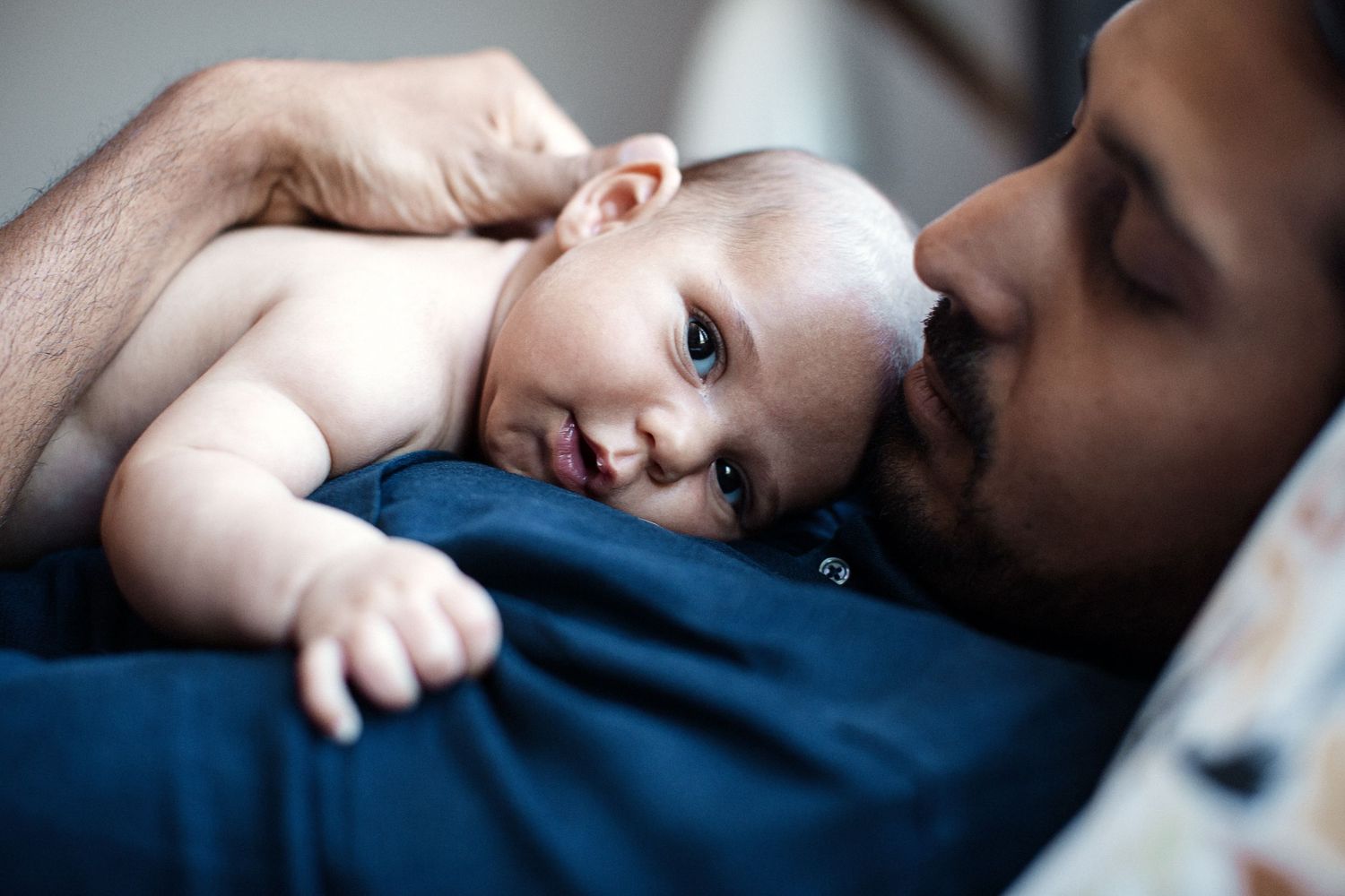 Father snuggling baby.