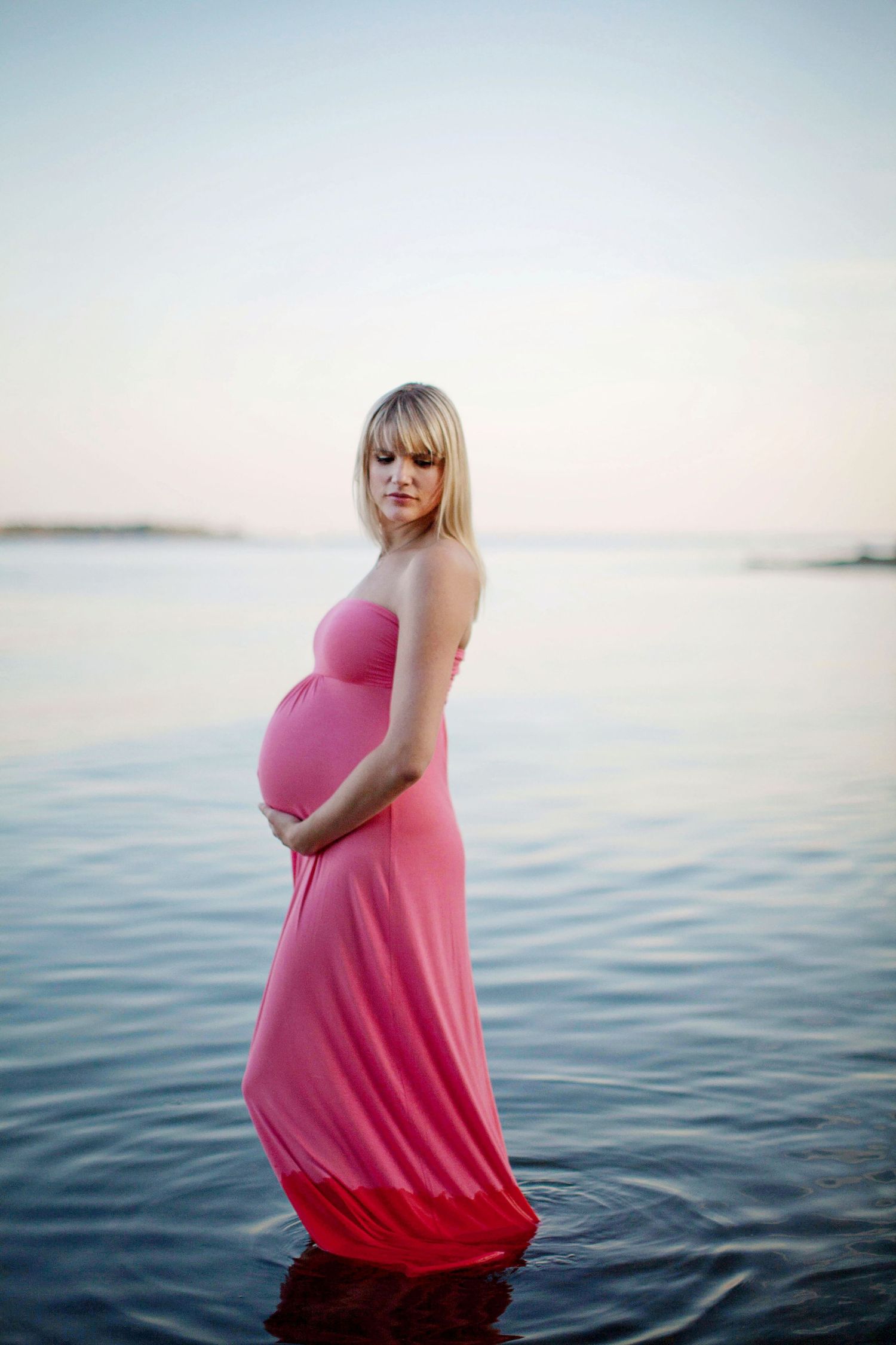 Maternity photo of a woman in a serene lake.