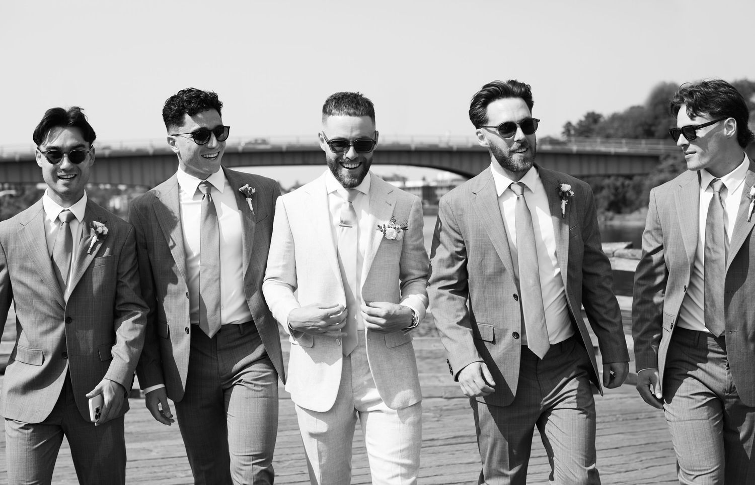 Groom and groomsmen walking toward camera..