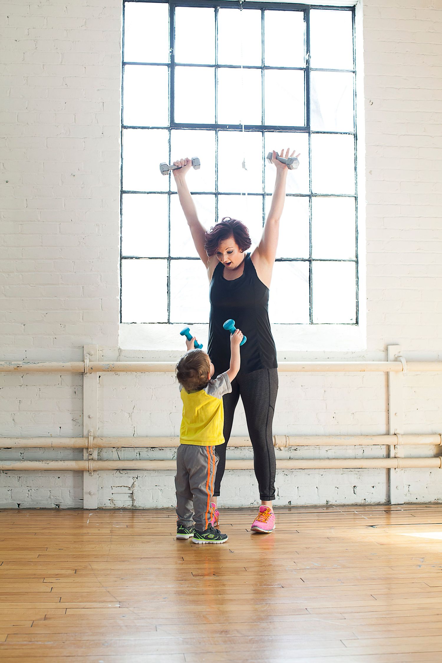 Woman and her child working out together.