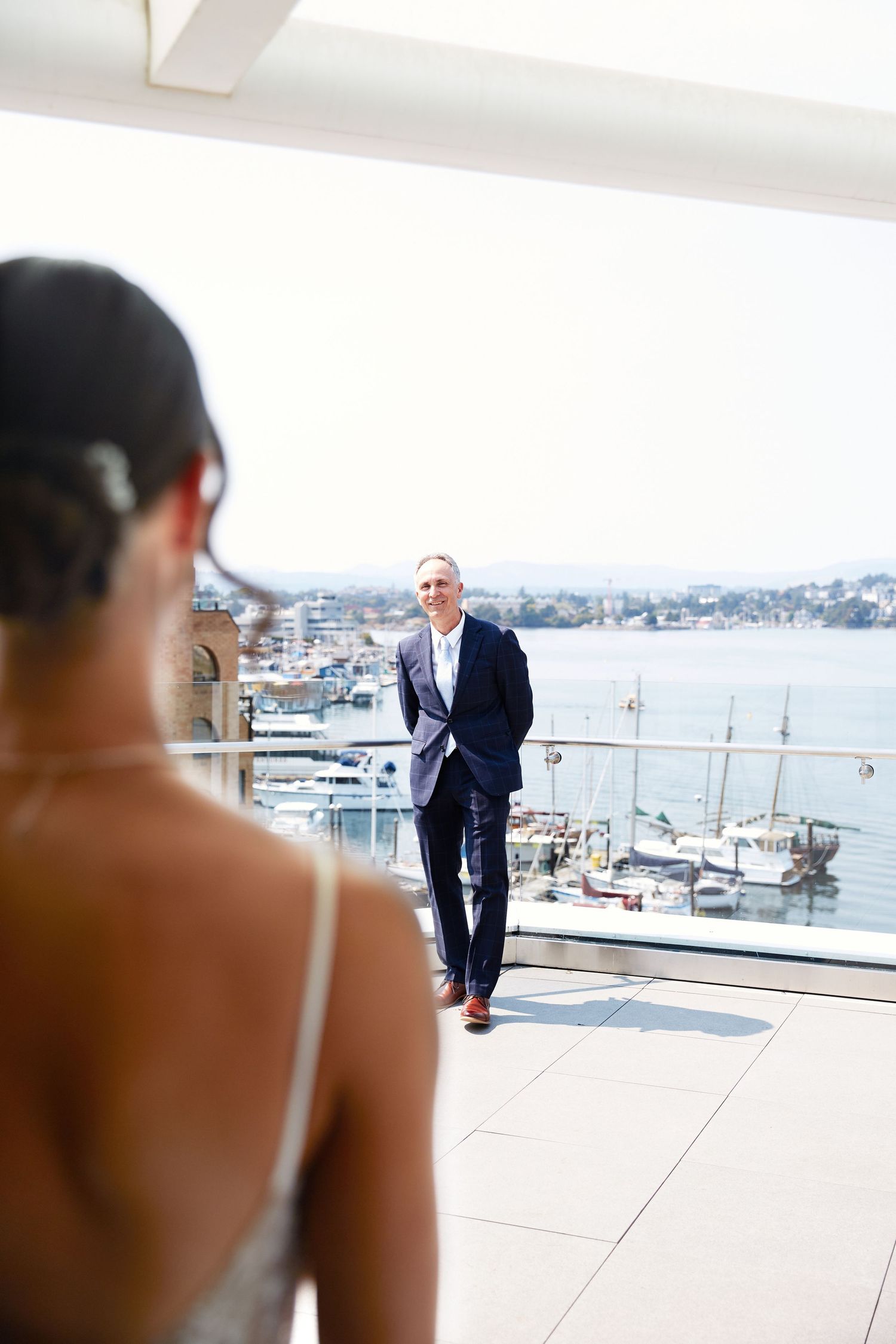Bride showing father her dress.