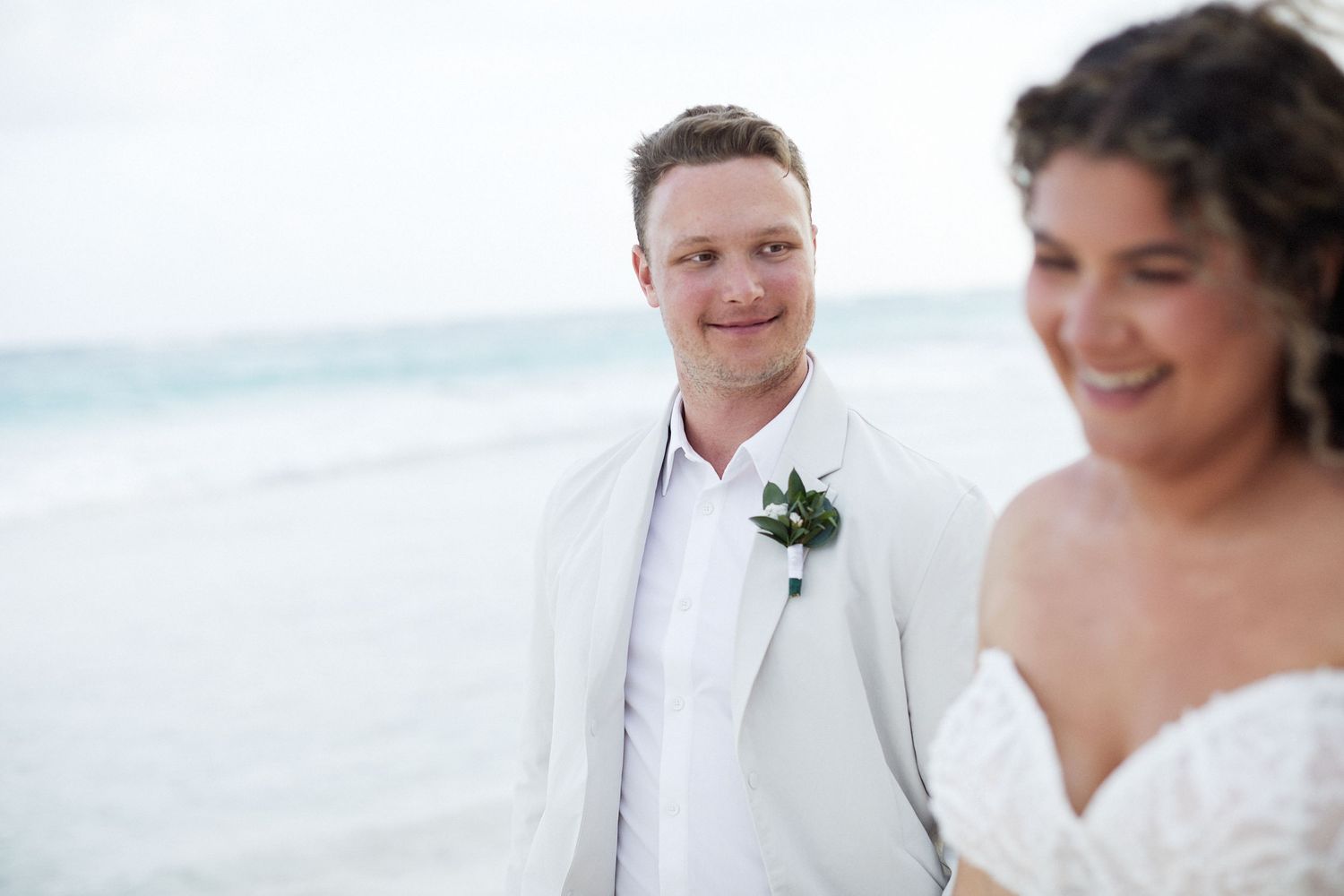 Groom looking at bride lovingly.