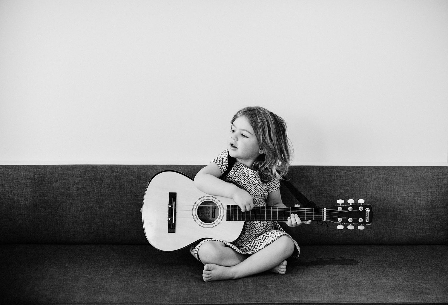 Small child playing guitar.