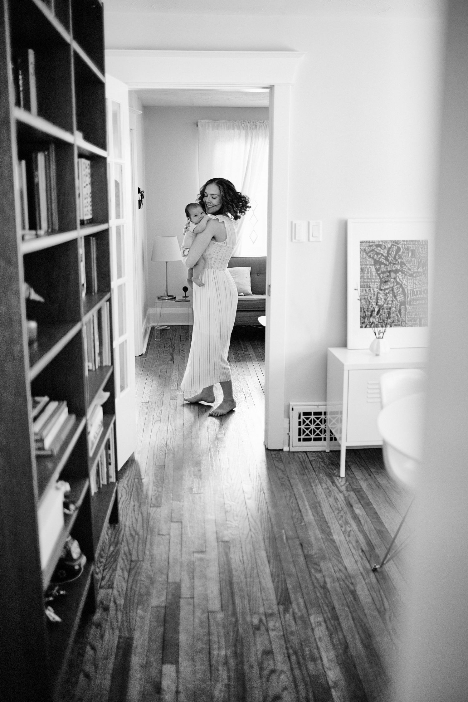 Mom dancing in hallway with baby.