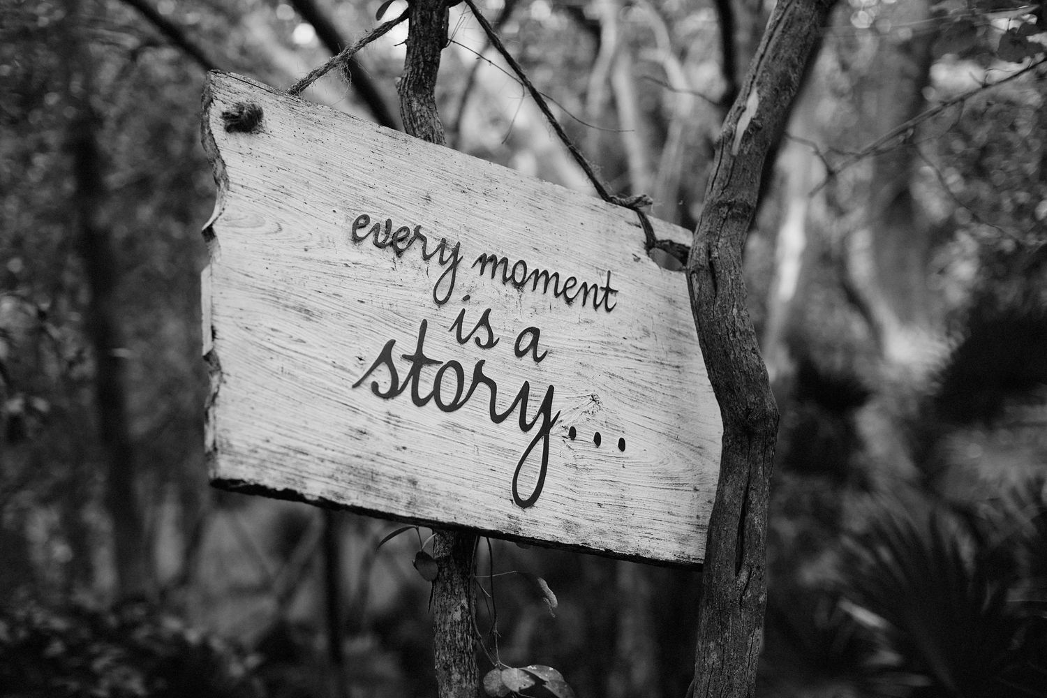 Photo of inspirational sign 'every moment is a story' at a resort.