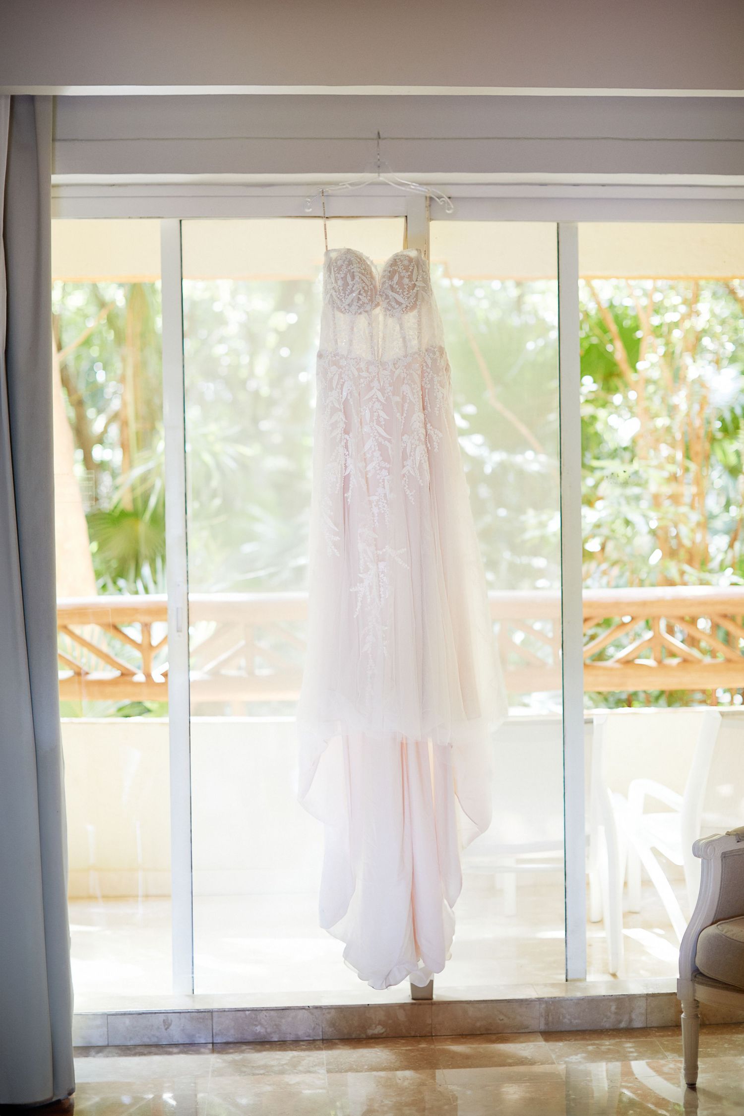 Brides wedding dress hanging.