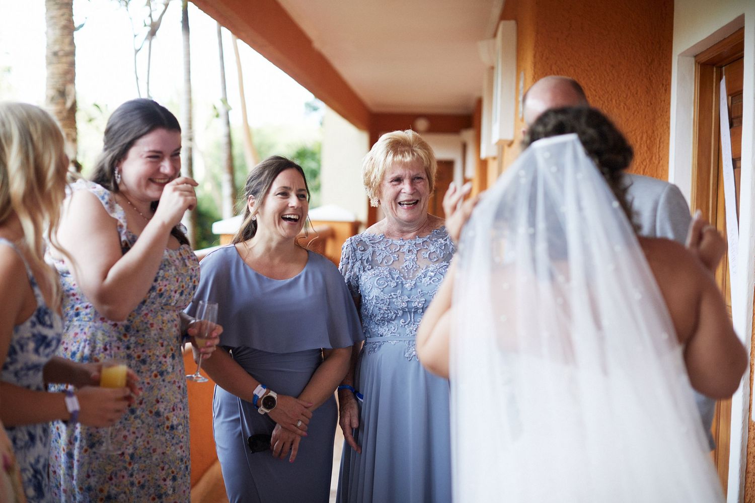 Bridesmaids and female wedding participants seeing the bride in her wedding dress.