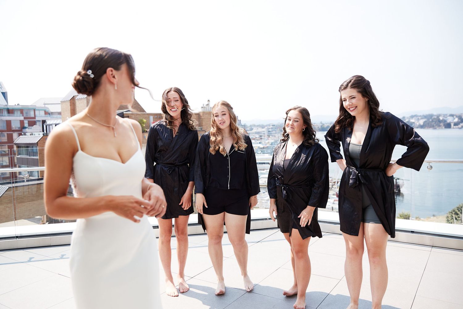Bride showing bridesmaids her dress.