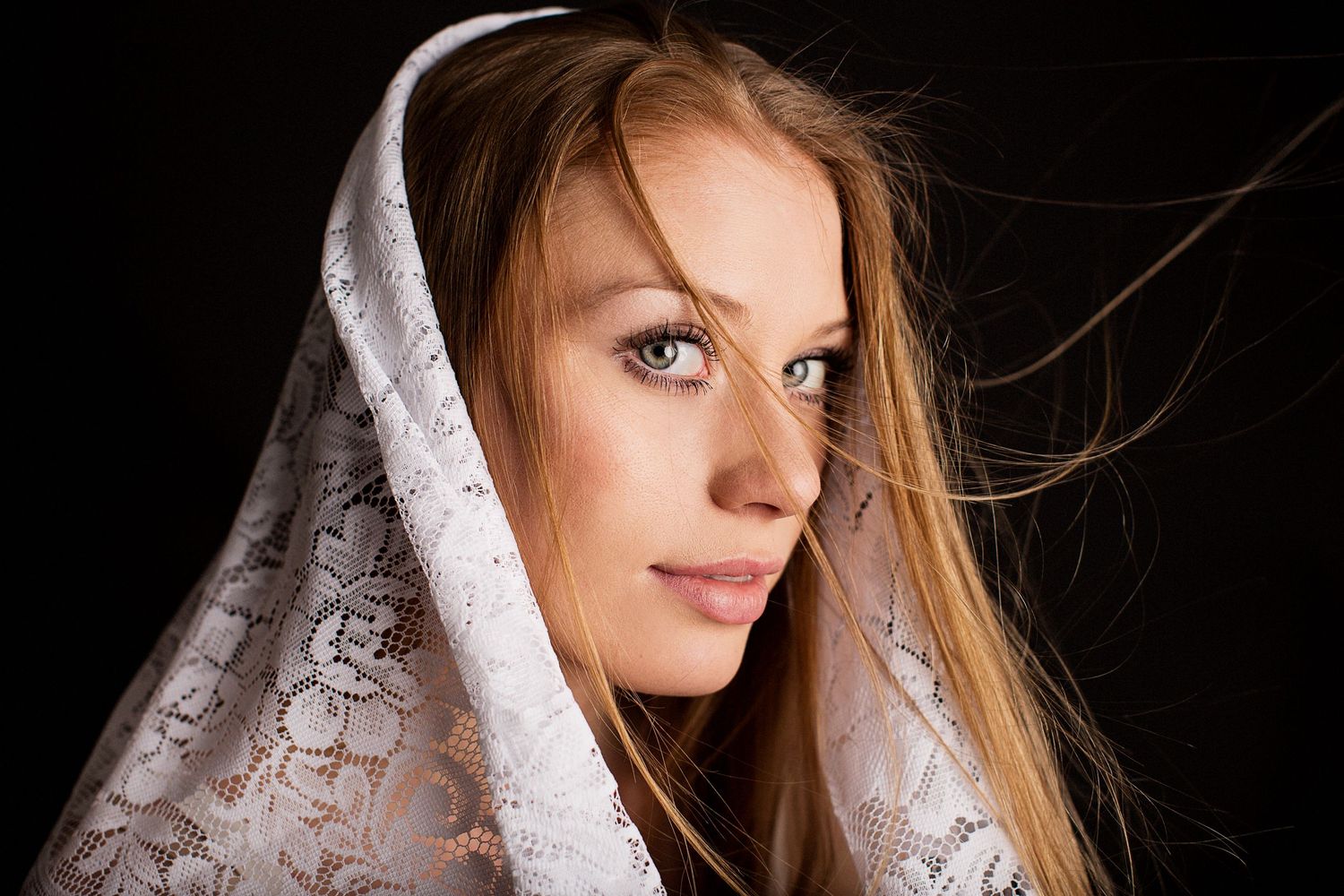 Model against black backdrop.